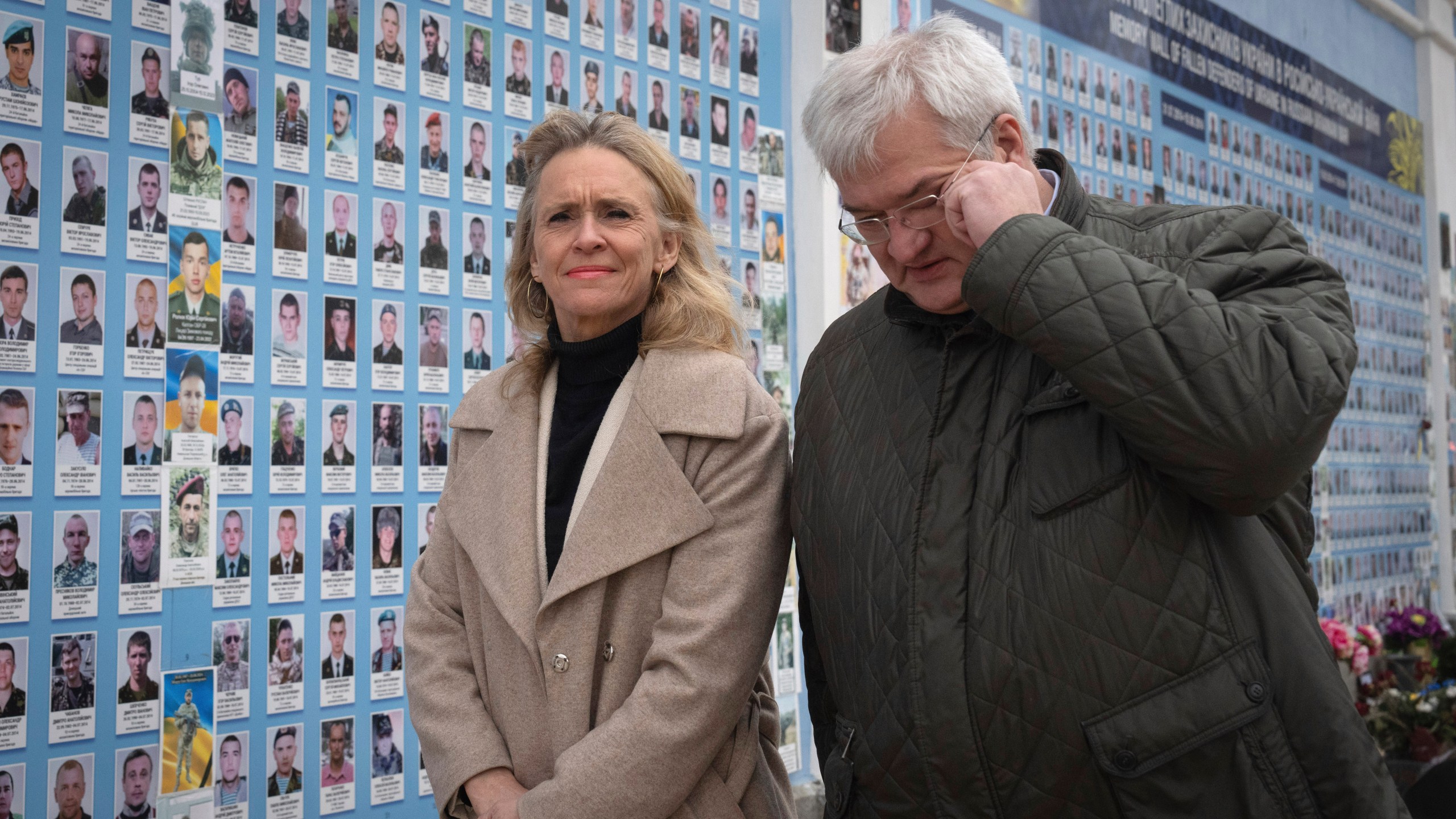 Iceland's Foreign Minister Thorgerdur Katrin Gunnarsdottir, left, and Ukraine's Foreign Minister Andriiy Sybiha attend a flower laying ceremony at the Memory Wall of Fallen Defenders of Ukraine in Kyiv, Ukraine, Tuesday, Jan. 7, 2025. (AP Photo/Efrem Lukatsky)