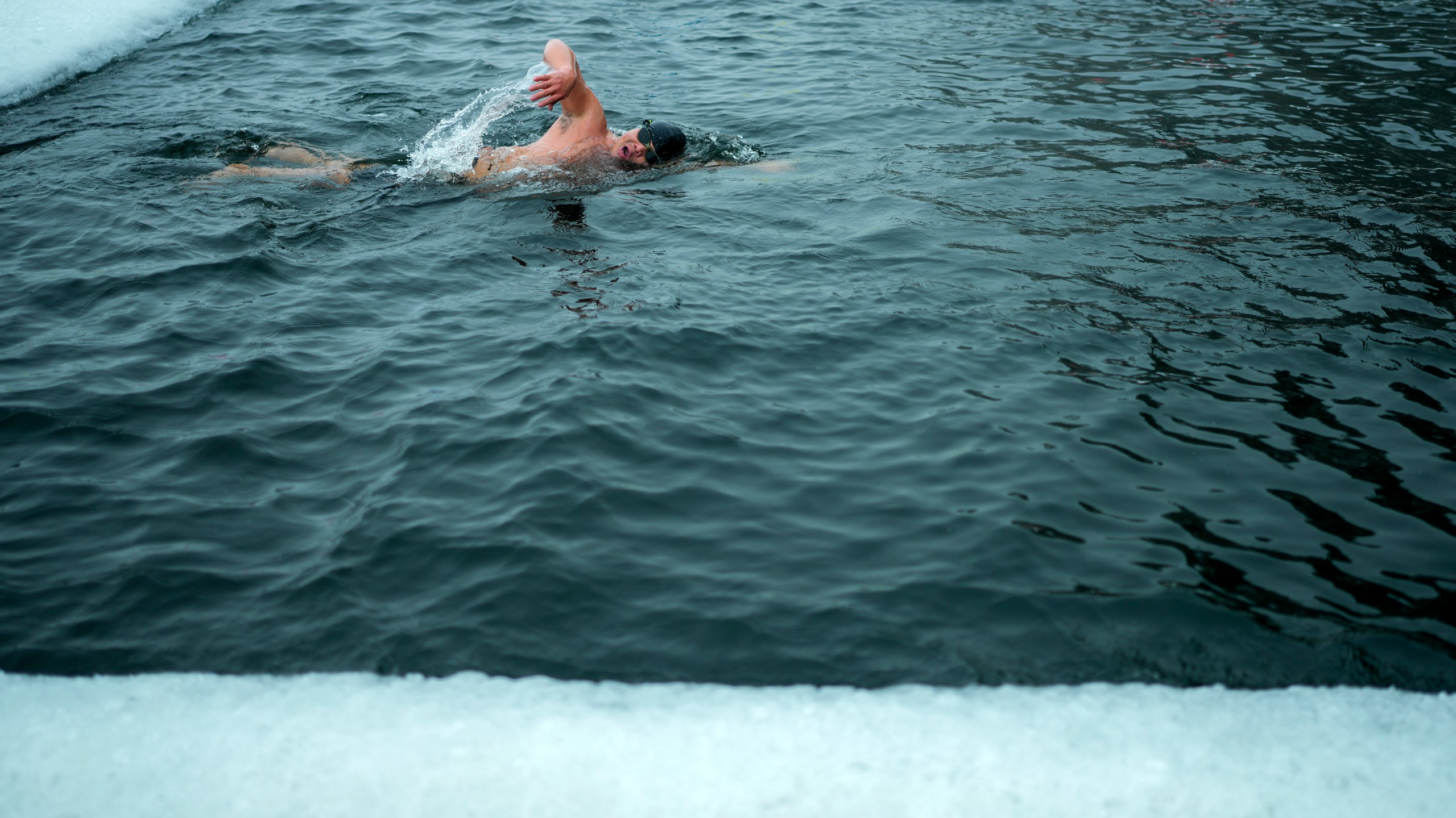 A resident swims in a pool carved from ice on the frozen Songhua river in Harbin in northeastern China's Heilongjiang province, Tuesday, Jan. 7, 2025. (AP Photo/Andy Wong)