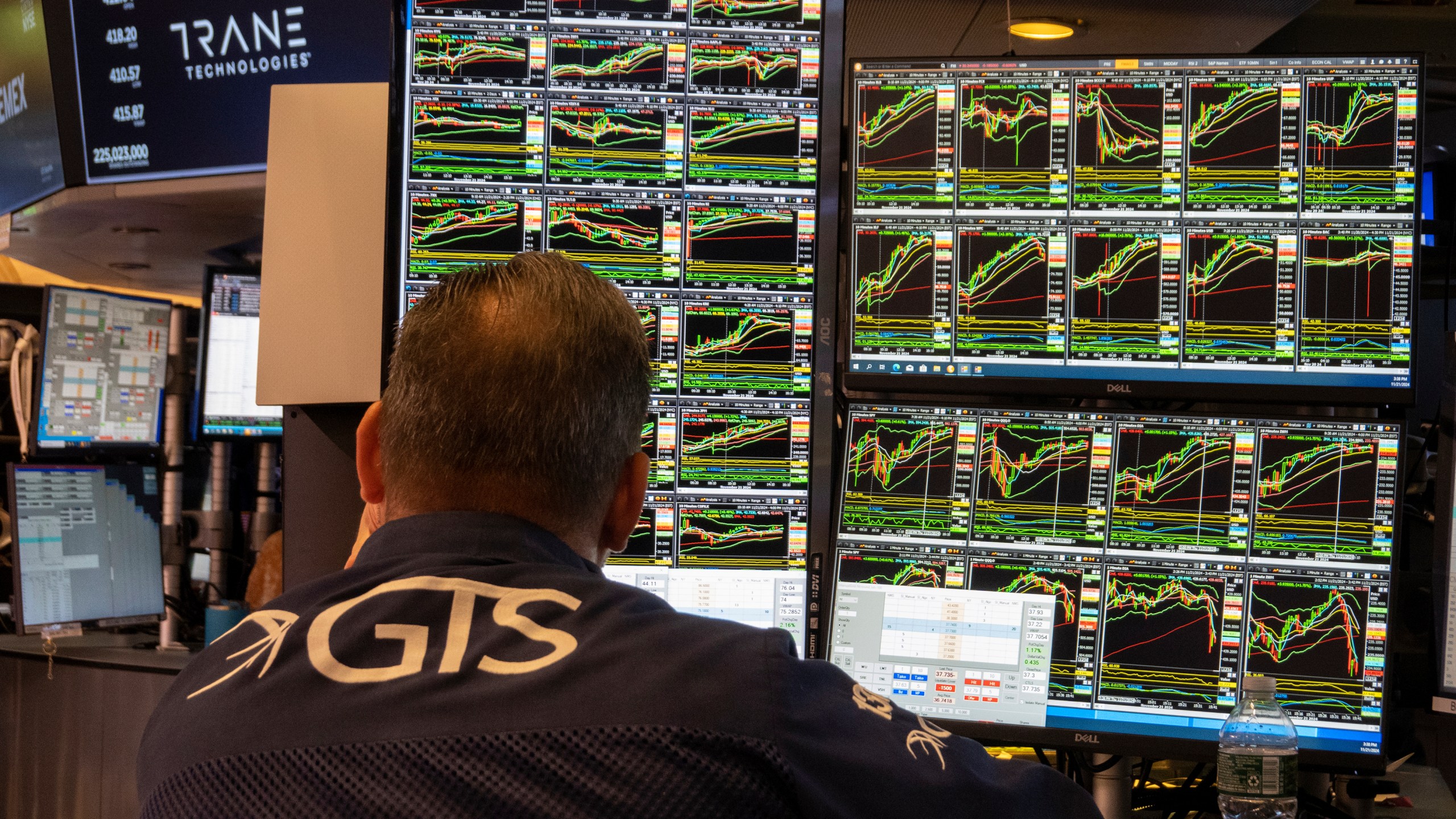 FILE - A specialist studies monitors on the New York Stock Exchange trading floor in New York on November 21, 2024. (AP Photo/Ted Shaffrey, File)