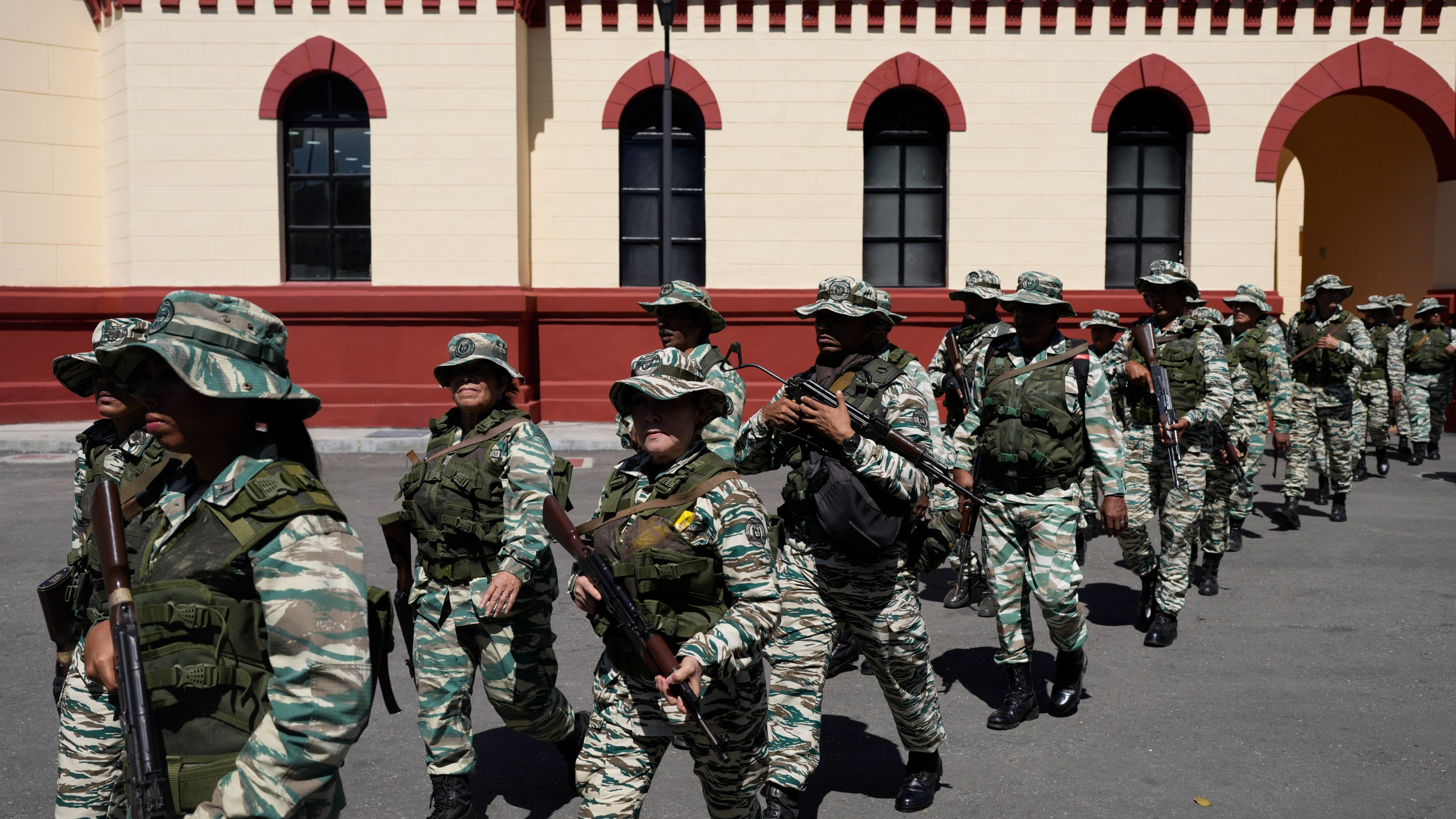 Bolivarian Militia members leave the 4F Military Museum for a gathering of security forces at Miraflores presidential palace in Caracas, Venezuela, Tuesday, Jan. 7, 2025, ahead of the presidential inauguration. (AP Photo/Matias Delacroix)