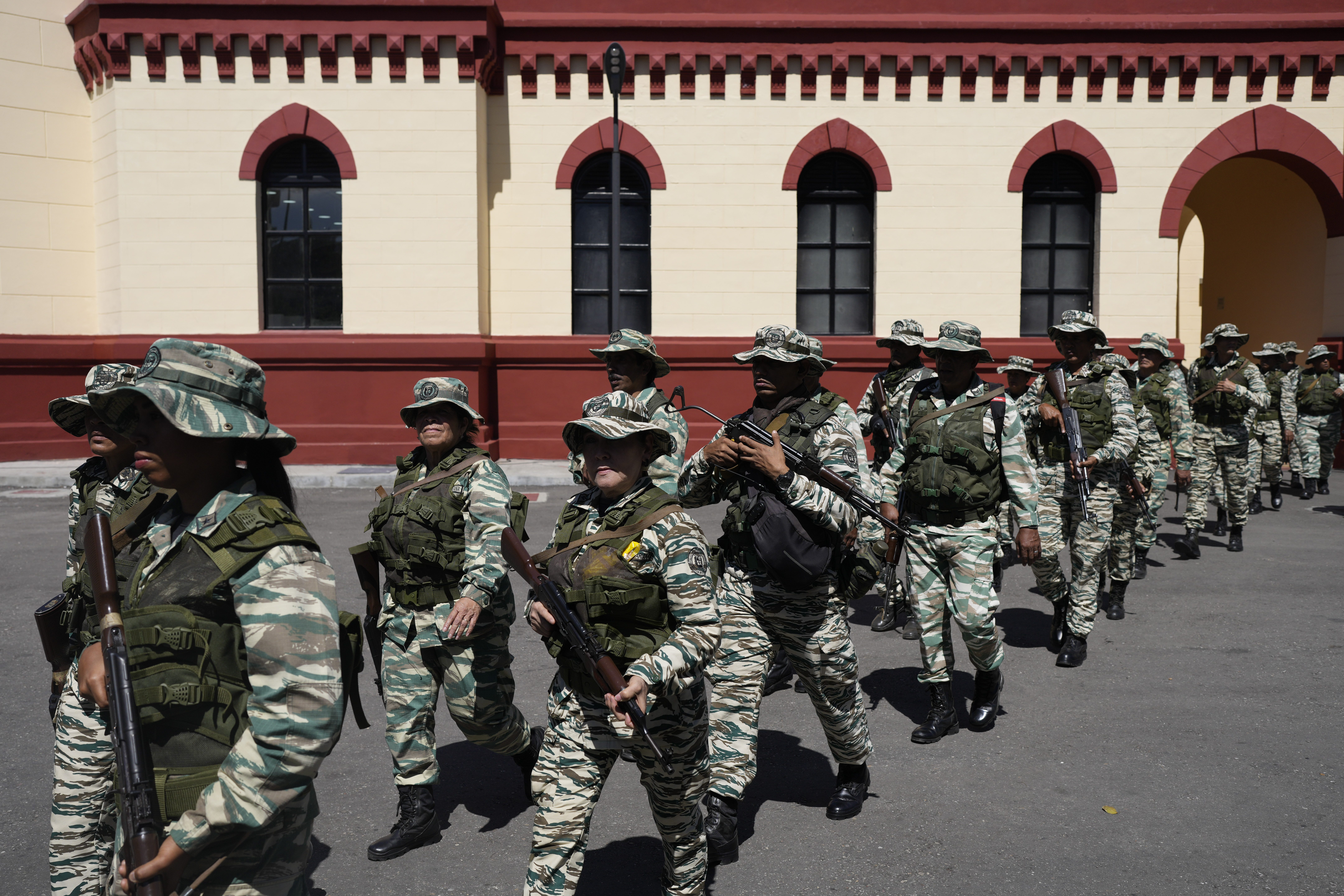 Bolivarian Militia members leave the 4F Military Museum for a gathering of security forces at Miraflores presidential palace in Caracas, Venezuela, Tuesday, Jan. 7, 2025, ahead of the presidential inauguration. (AP Photo/Matias Delacroix)