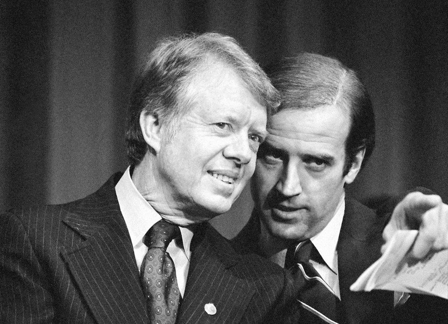 FILE - President Jimmy Carter listens to Sen. Joseph R. Biden, D-Del., as they wait to speak at fund raising reception at Padua Academy in Wilmington, Del., Feb. 20, 1978. (AP Photo/Barry Thumma, File)