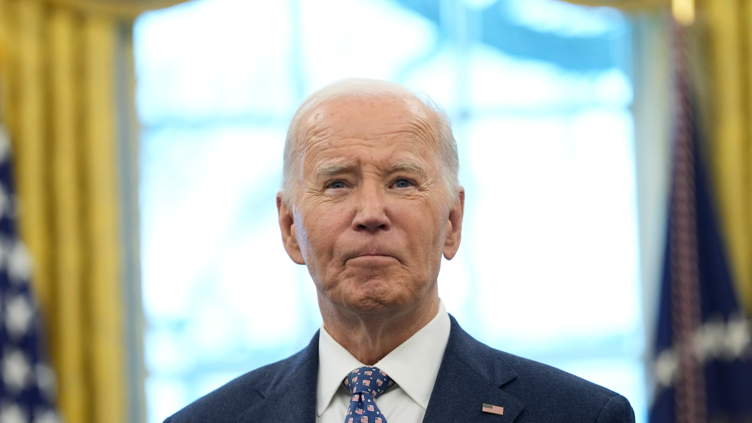 FILE - President Joe Biden pauses during a photo opportunity with Medal of Valor recipients in the Oval Office of the White House in Washington, Jan. 3, 2025. (AP Photo/Susan Walsh, File)