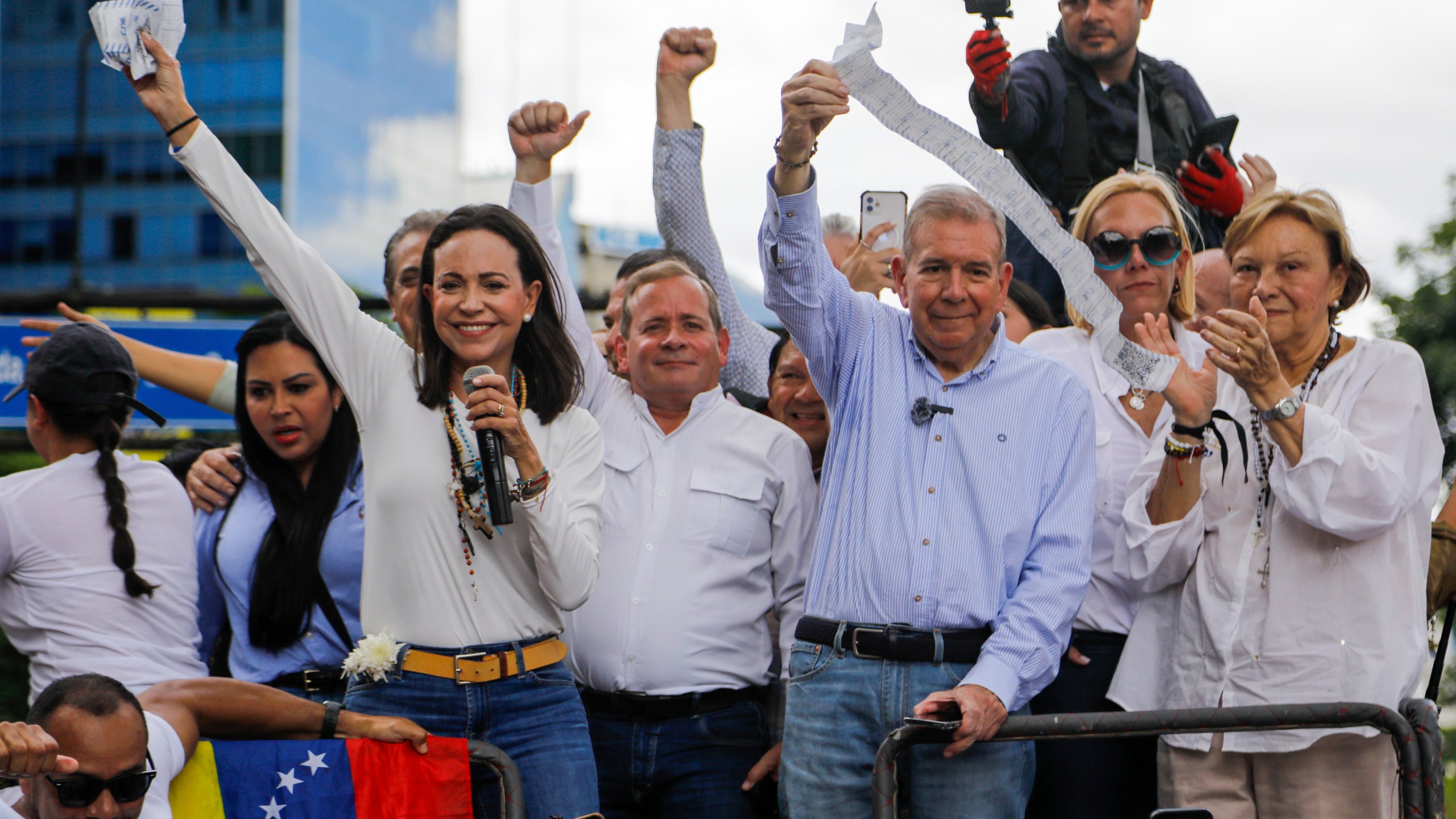 FILE - Opposition leader Maria Corina Machado, left, and opposition candidate Edmundo Gonzalez hold up vote tally sheets from the top of a truck during a protest against the official presidential election results declaring President Nicolas Maduro the winner in Caracas, Venezuela, July 30, 2024, two days after the election. (AP Photo/Cristian Hernandez, File)