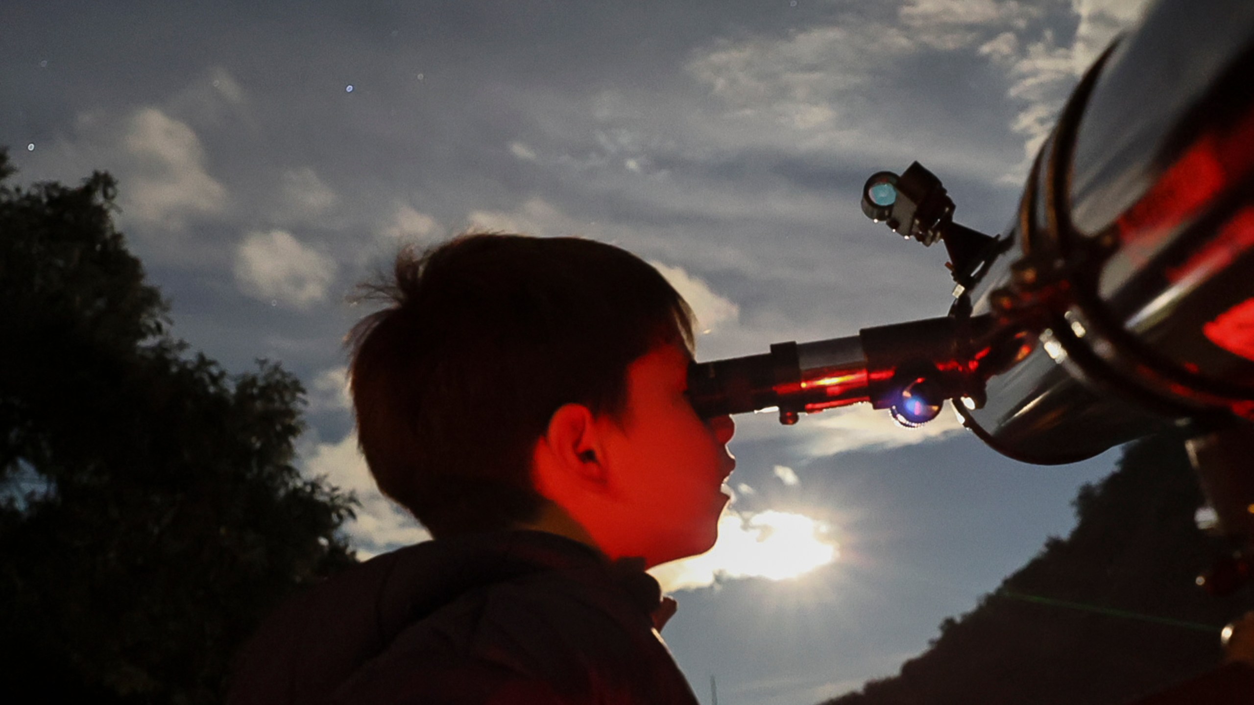 FILE - A youth looks through a telescope during a stargazing and comet-watching gathering at Joya-La Barreta Ecological Park in Queretaro, Mexico, Saturday, Oct. 19, 2024. (AP Photo/Ginnette Riquelme, File)