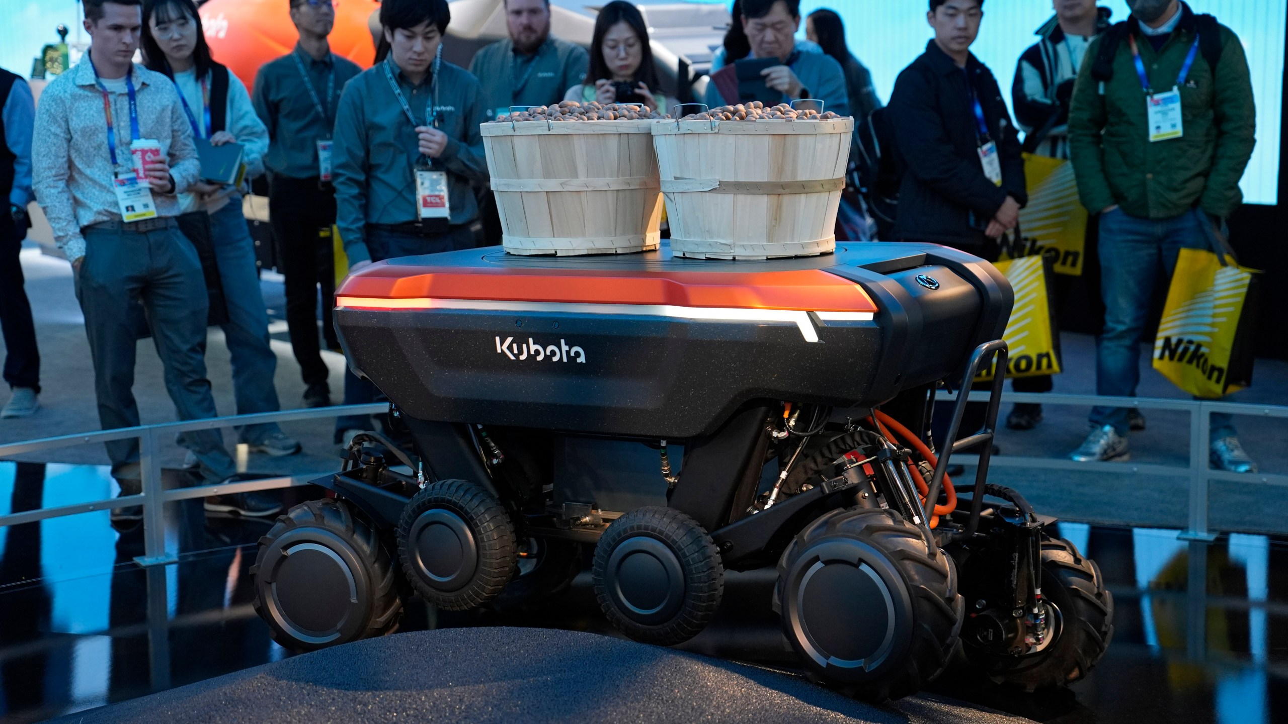 People view a demonstration of the KATR robot designed to work in agriculture and construction at the Kubota booth during the CES tech show Tuesday, Jan. 7, 2025, in Las Vegas. (AP Photo/John Locher)