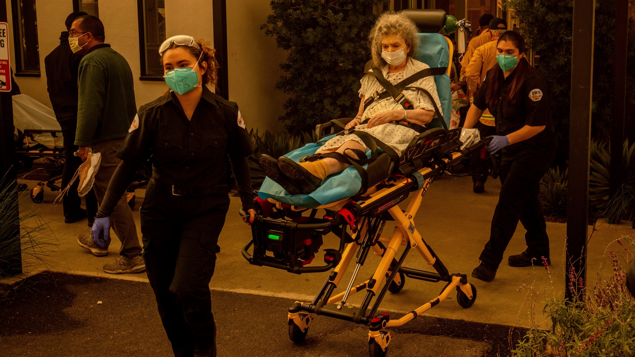 A resident is evacuated from a senior living facility as the Eaton Fire approaches Wednesday, Jan. 8, 2025, in Altadena, Calif. (AP Photo/Ethan Swope)