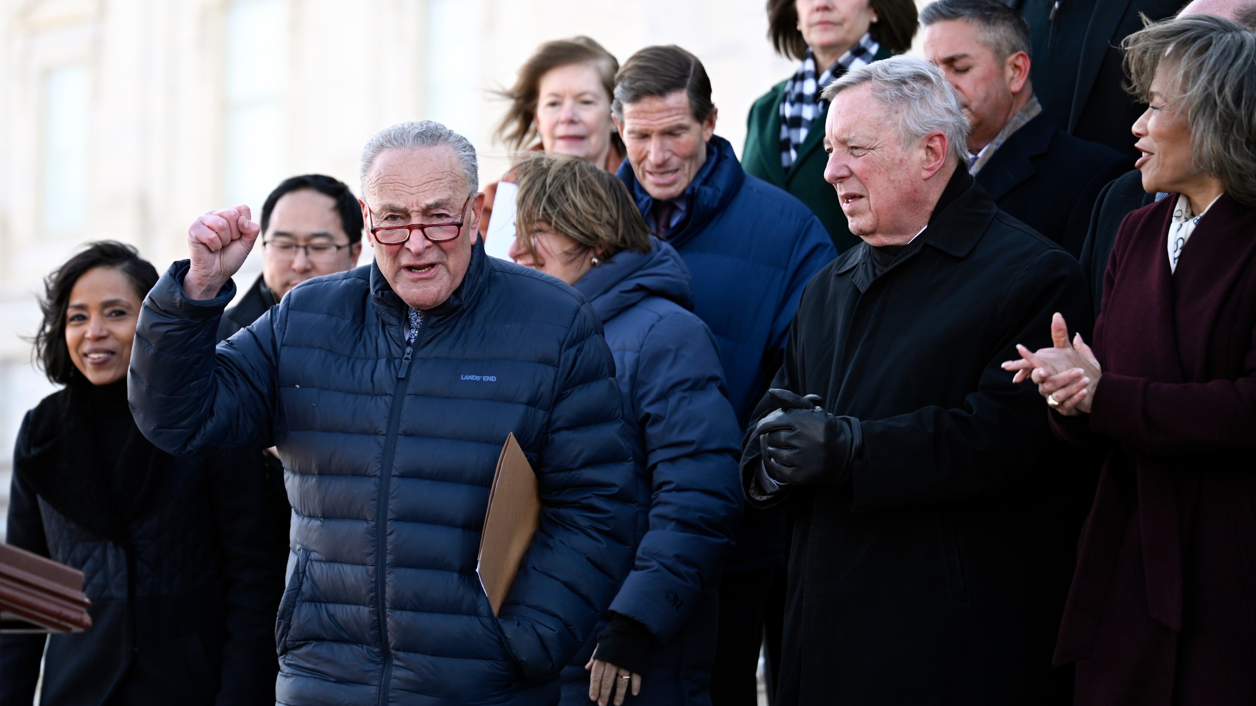 Senate Minority Leader Chuck Schumer, D-N.Y., third left, and Senate Democrats layout the priorities for the 119th Congress on the Senate Steps at the U.S. Capitol on Thursday, Jan. 9, 2025, in Washington. (AP Photo/John McDonnell)