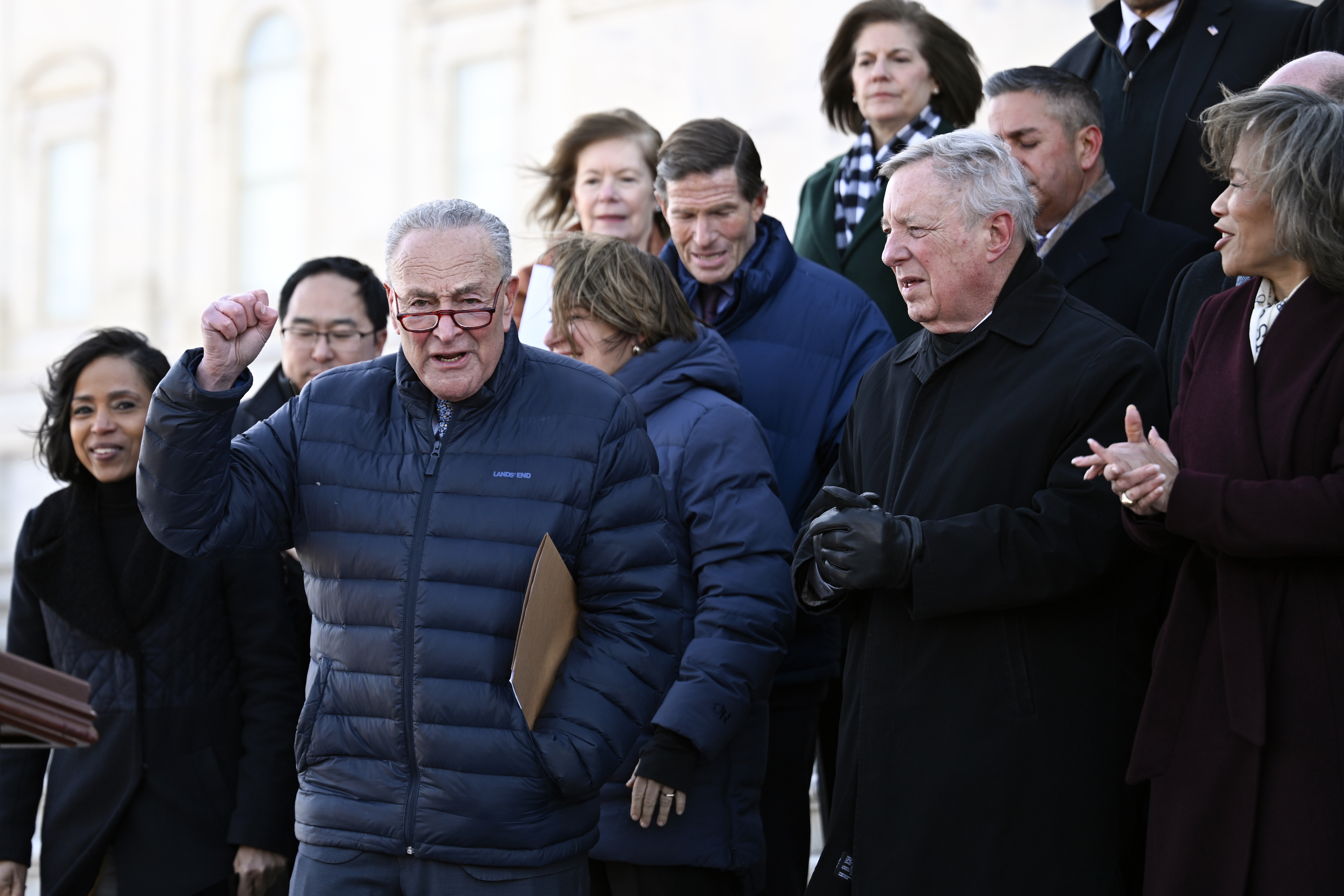 Senate Minority Leader Chuck Schumer, D-N.Y., third left, and Senate Democrats layout the priorities for the 119th Congress on the Senate Steps at the U.S. Capitol on Thursday, Jan. 9, 2025, in Washington. (AP Photo/John McDonnell)