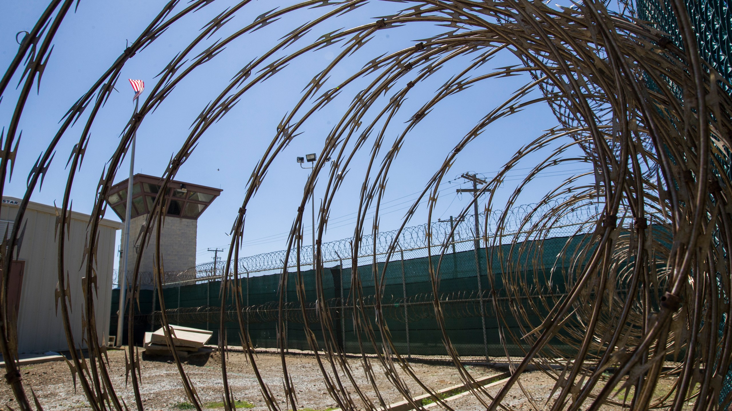 FILE - In this April 17, 2019, photo, reviewed by U.S. military officials, the control tower is seen through the razor wire inside the Camp VI detention facility in Guantanamo Bay Naval Base, Cuba. (AP Photo/Alex Brandon, File)