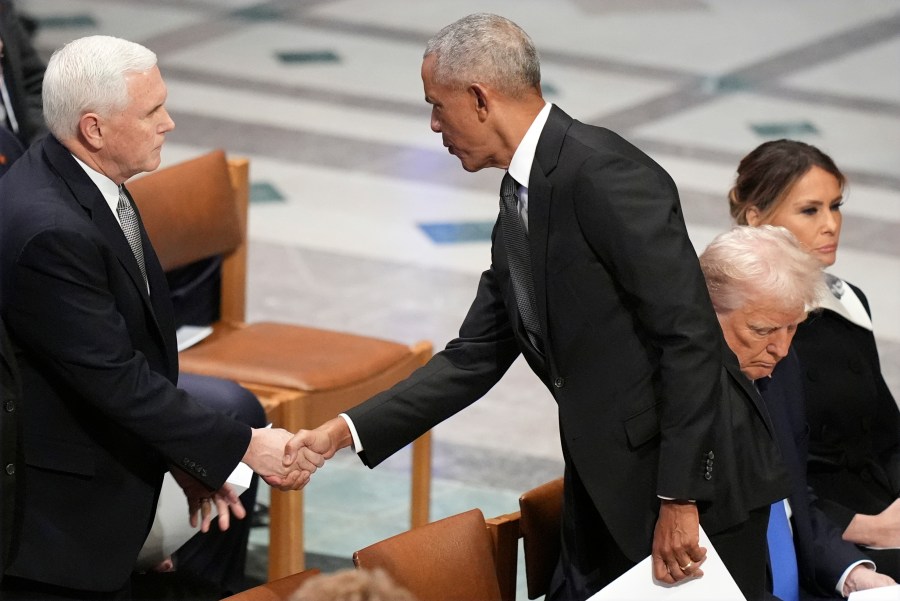 Former President Barack Obama shakes hands with former Vice President Mike Pence before the state funeral for former President Jimmy Carter at Washington National Cathedral in Washington, Thursday, Jan. 9, 2025, as President-elect Donald Trump sits with Melania Trump at right. (AP Photo/Jacquelyn Martin)