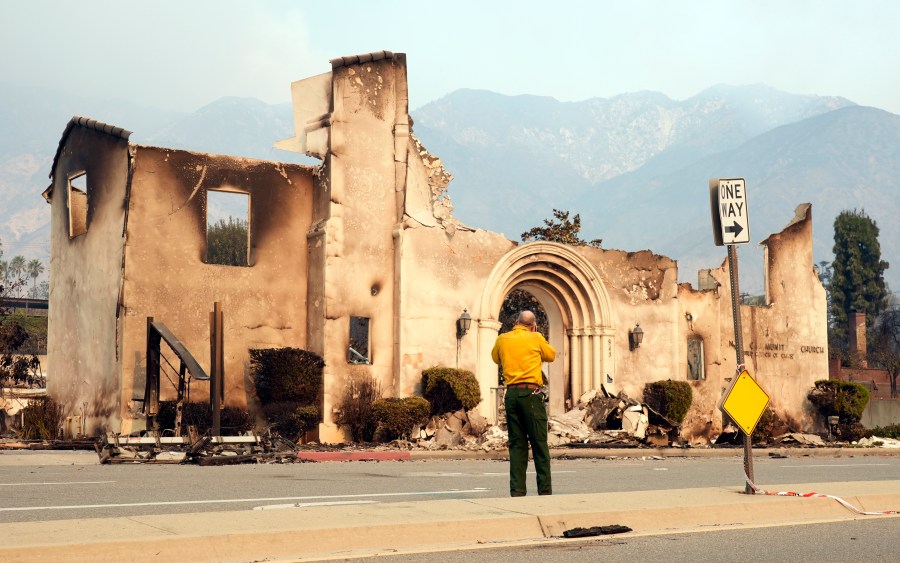 A man photographs the destroyed Altadena Community Church, Thursday, Jan. 9, 2025, in the Altadena section of Pasadena, Calif. (AP Photo/Chris Pizzello)