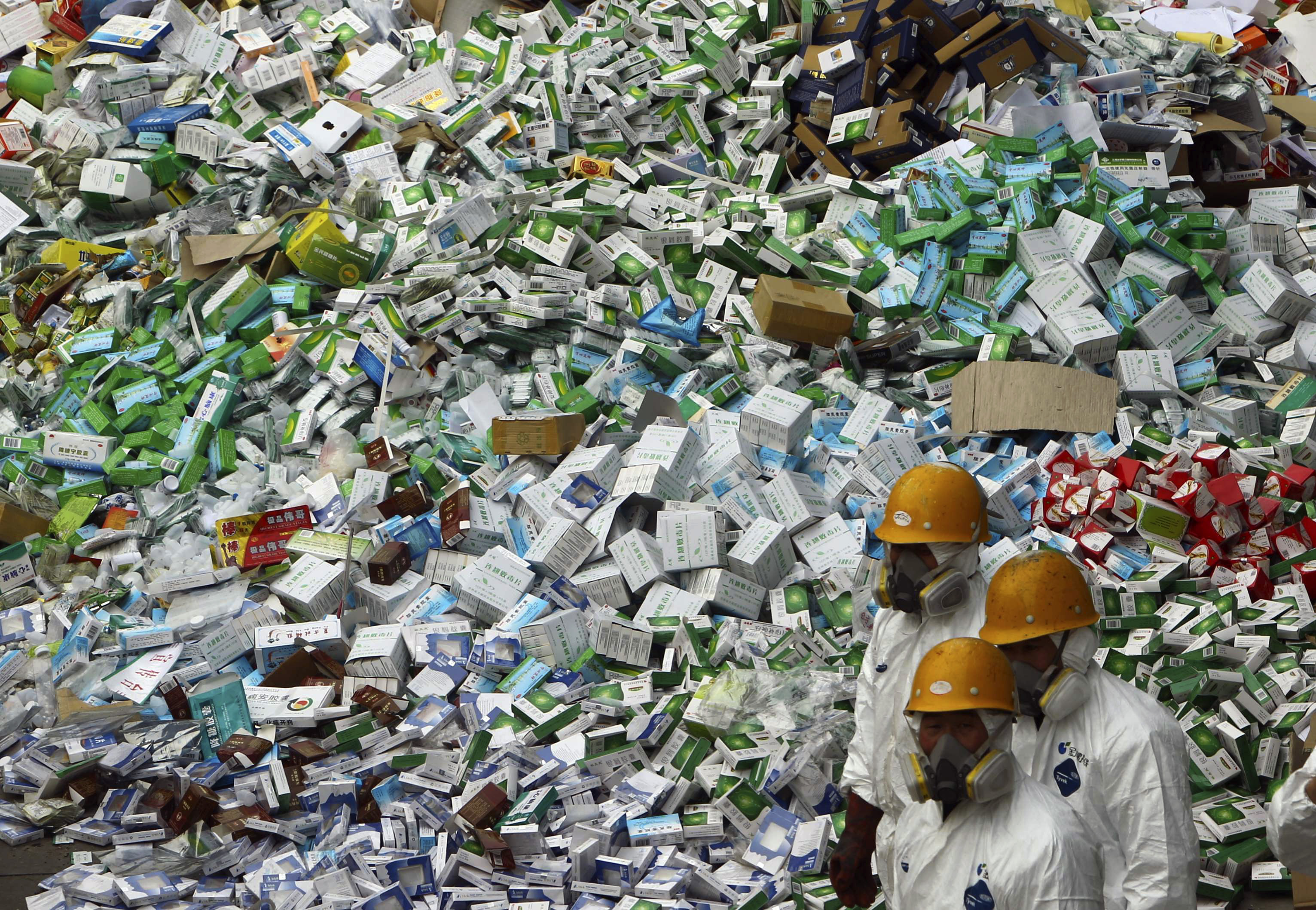 FILE - Workers prepare to destroy over 50 tons of confiscated fake medicine during a campaign to mark World Consumer Rights Day in Beijing, Thursday March 15, 2012. (AP Photo/File)