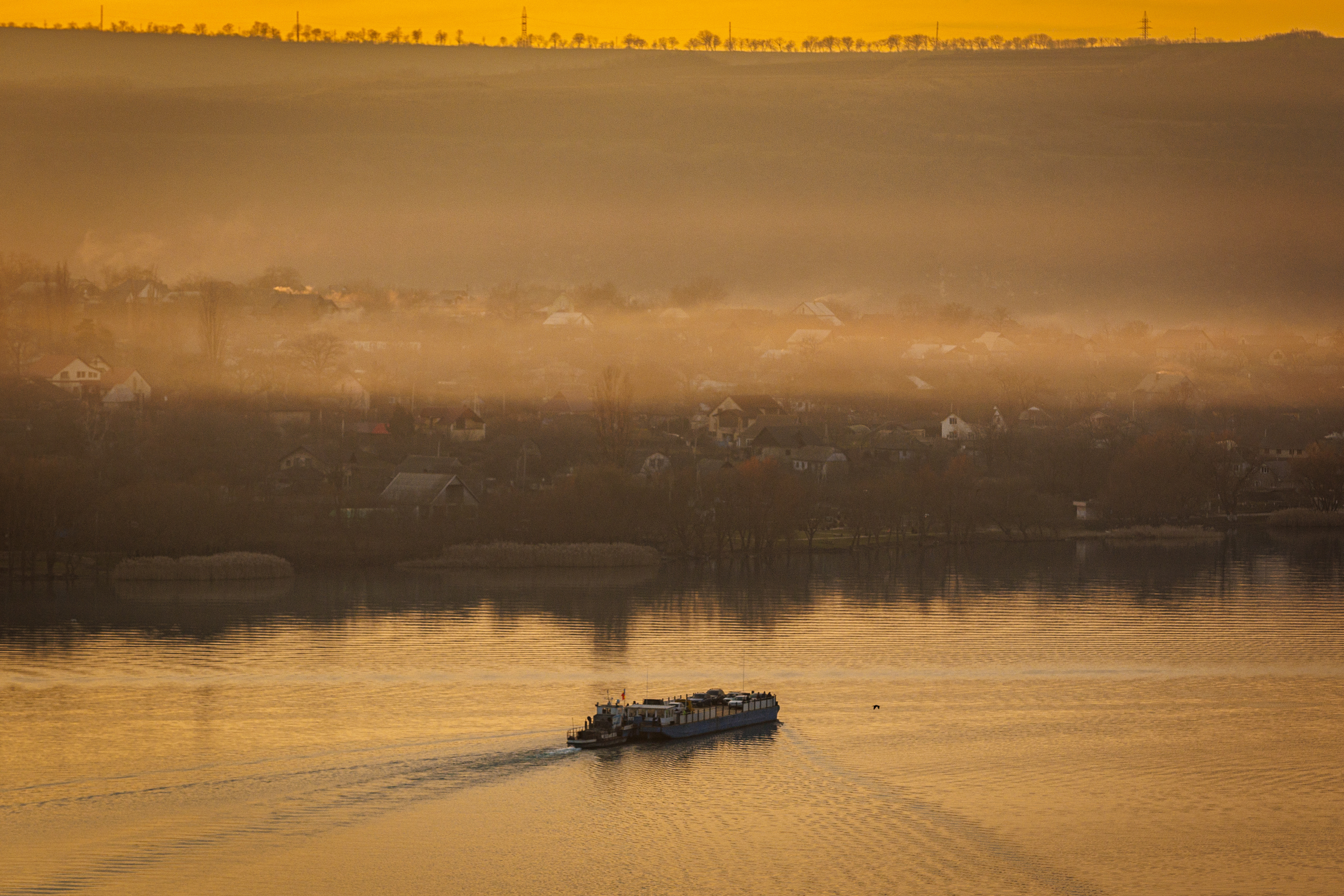 A ferry sails to the left bank of the Dniester river, the border between Moldova and Transnistria, seen from Molovata, Moldova, Wednesday, Jan. 8, 2025. (AP Photo)