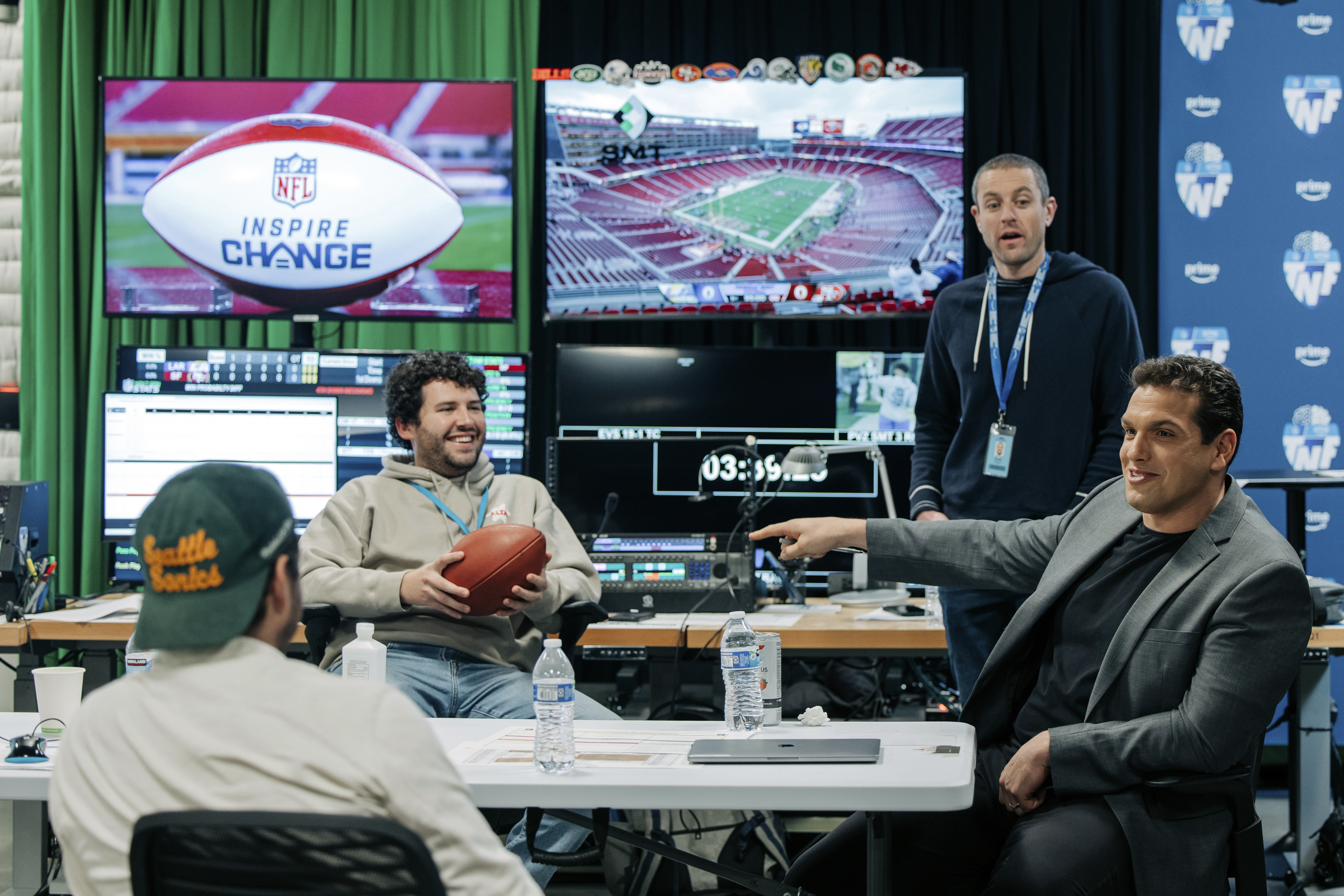 IN this image provided by Amazon Prime Video, from left, Prime Video Senior Coordinating Producer Alex Strand; Keegan Abdoo of the NFL’s Next Gen Stats Department; Scott Karpen, Producer of “Prime Vision with Next Gen Stats”; and Prime Video “Thursday Night Football” analytics expert Sam Schwartzstein talk at the Amazon/MGM Studios in Culver City, Calif., Thursday, Dec 12, 2024, , before the Los Angeles Rams-San Francisco 49ers NFL football game. (Timothy Buckman/Amazon Prime Video via AP)