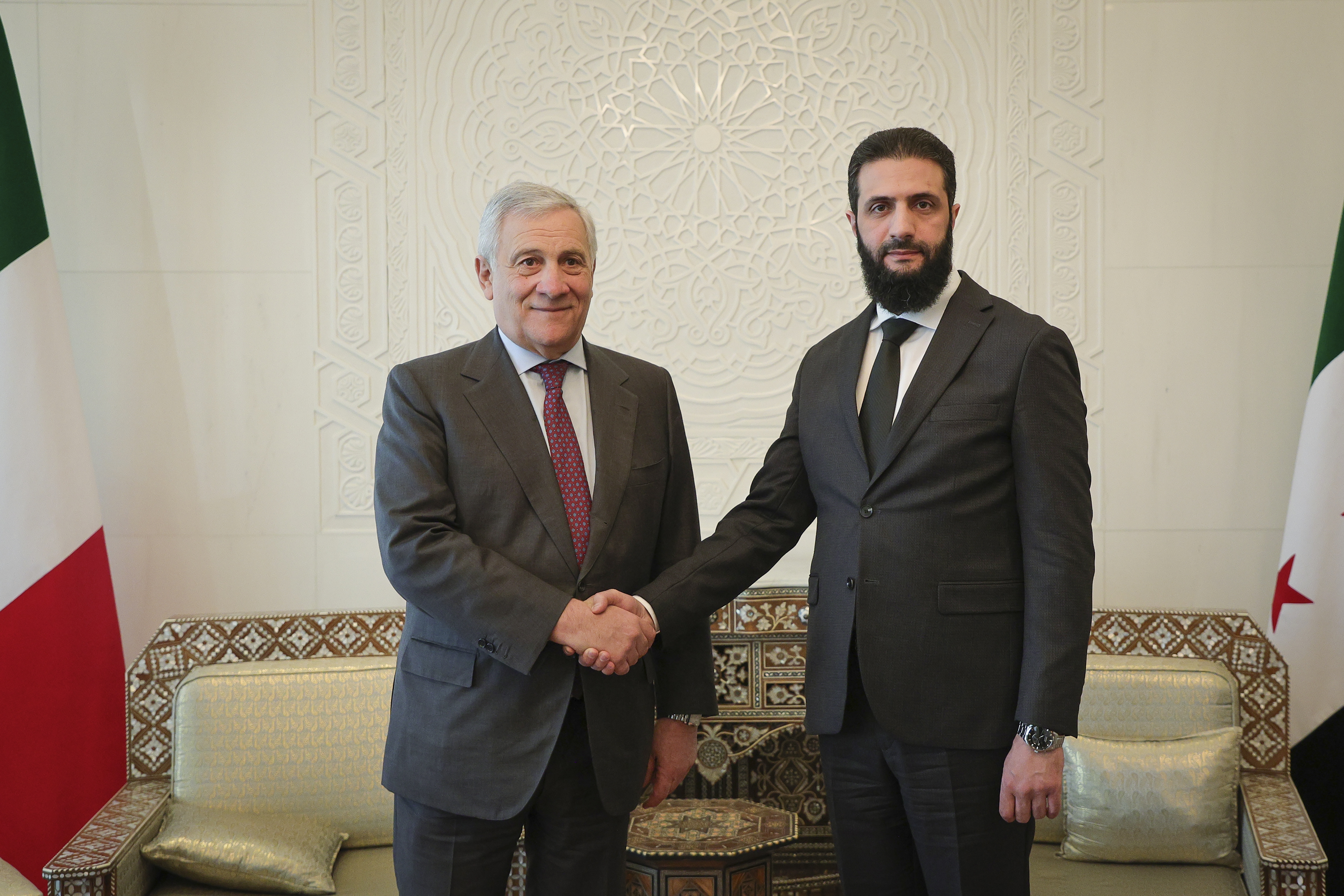 In this photo released by the Syrian official news agency SANA, Syria's de facto leader Ahmad al-Sharaa, formerly known as Abu Mohammed al-Golani, right, meets with Italian foreign minister Antonio Tajani in Damascus, Syria, Friday, Jan. 10, 2025. (SANA via AP)