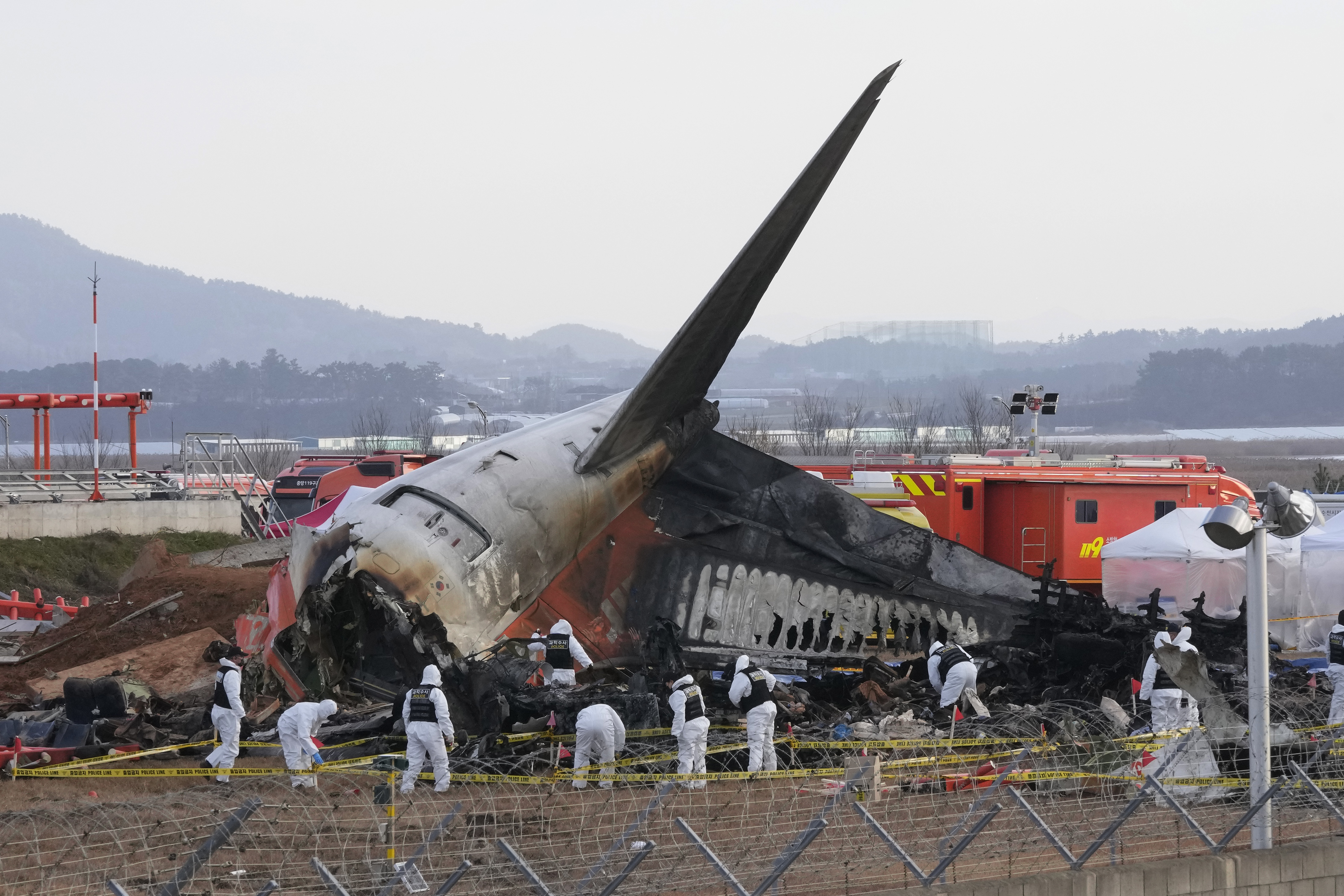 FILE - Rescue team members work at the site of a plane crash at Muan International Airport in Muan, South Korea on Dec. 31, 2024. (AP Photo/Ahn Young-joon, File)