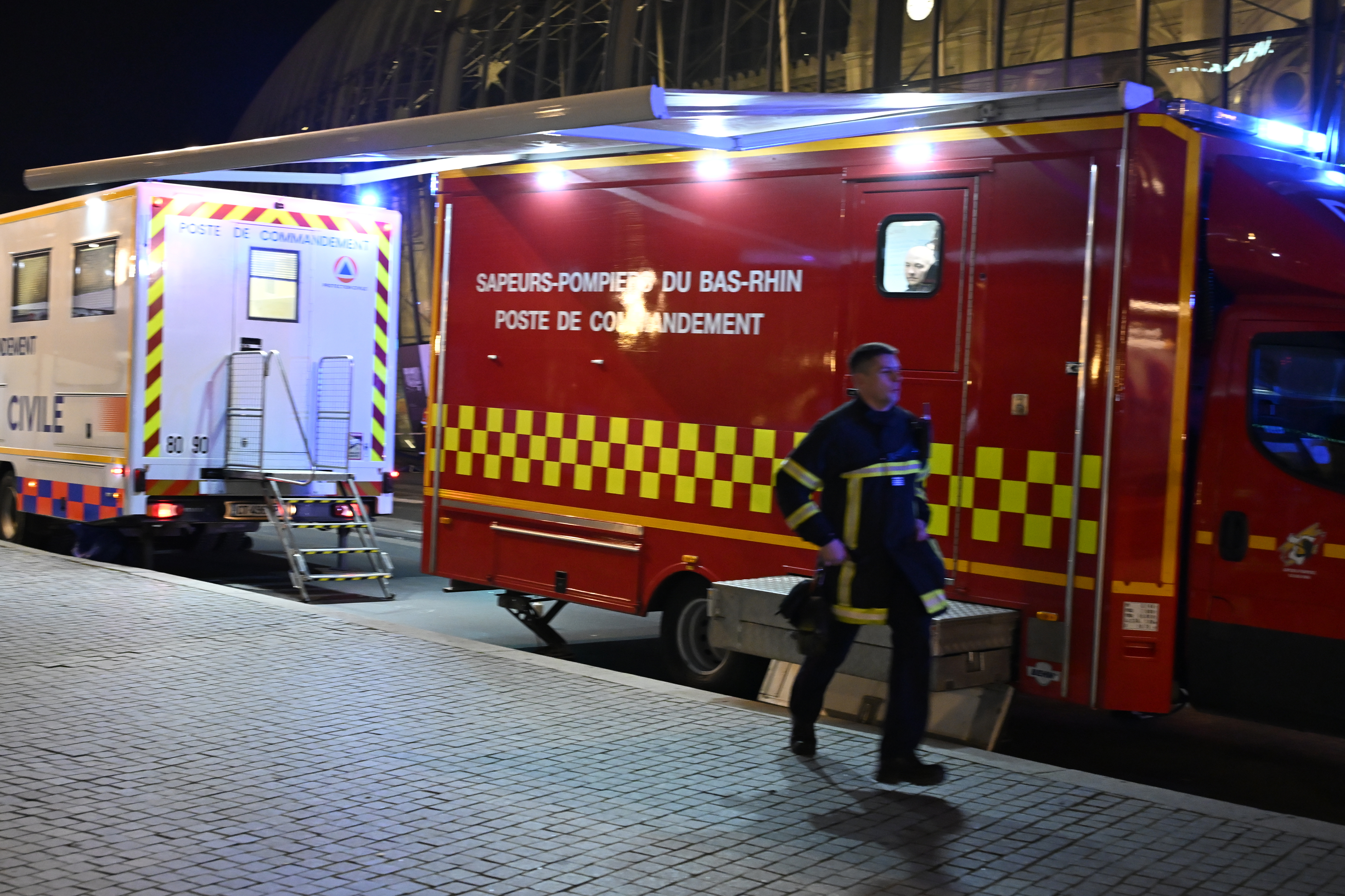 A firefighter rushes to the train station after two trams collided, injuring dozens of people, though none critically, firefighters said, Saturday, Jan. 11, 2025 in Strasbourg, eastern France. (AP Photo/Pascal Bastien)