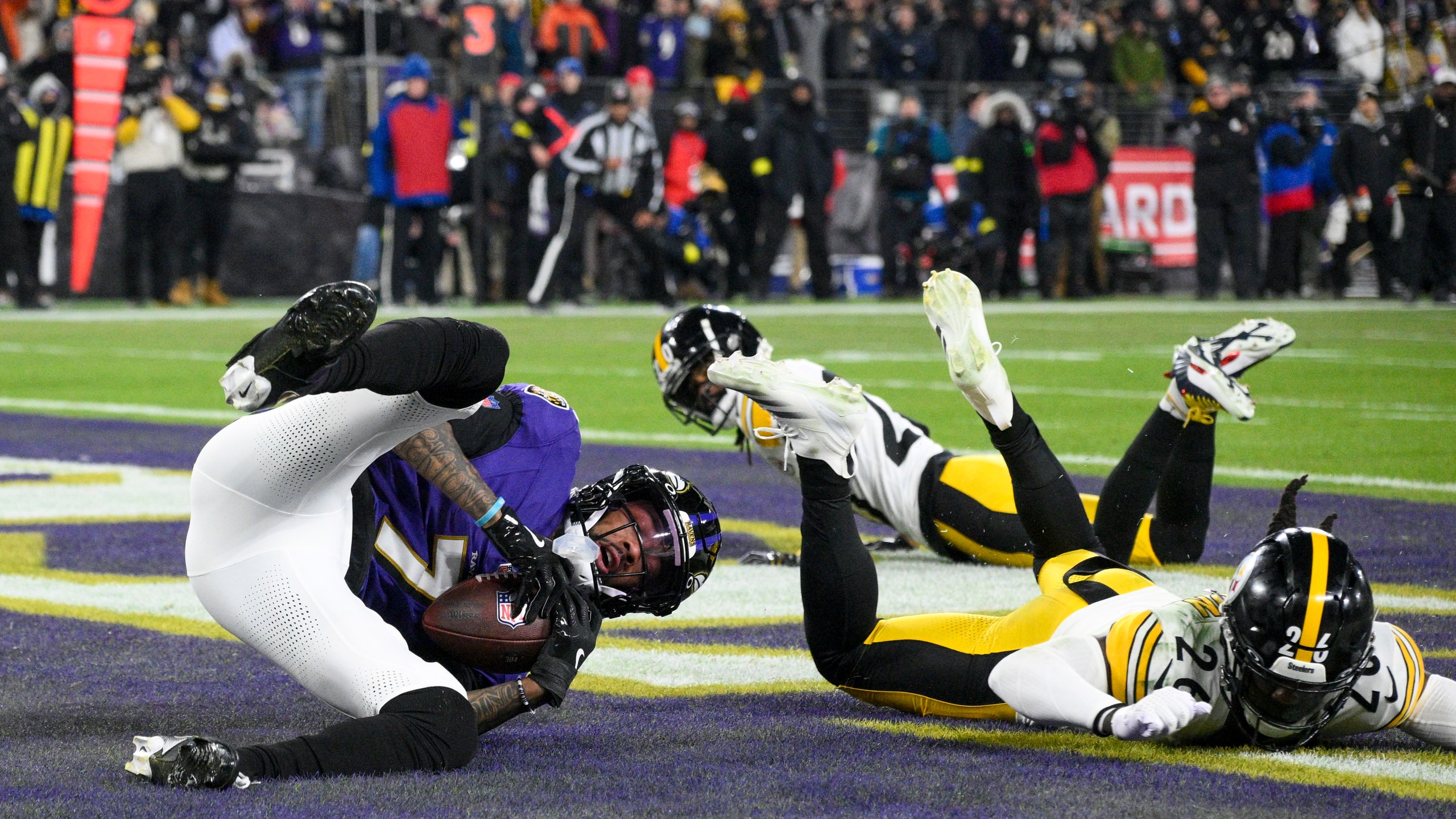 Baltimore Ravens wide receiver Rashod Bateman, left, catches a touchdown pass from quarterback Lamar Jackson, not visible, in front of Pittsburgh Steelers cornerback Donte Jackson (26) and cornerback Cameron Sutton during the first half of an NFL wild-card playoff football game, Saturday, Jan. 11, 2025, in Baltimore. (AP Photo/Nick Wass)