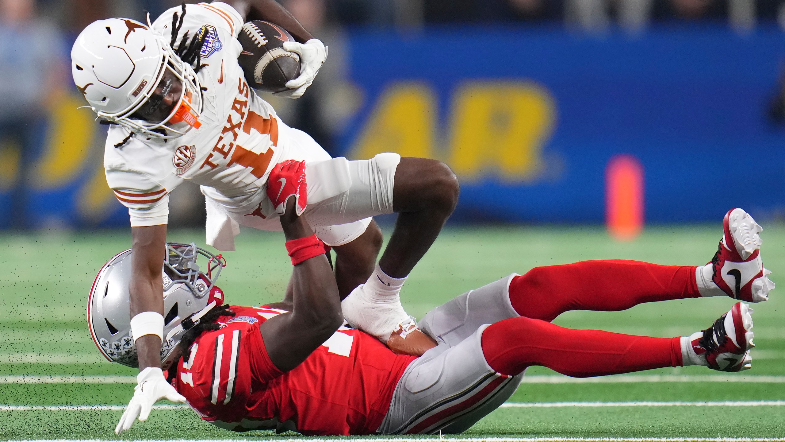 Texas wide receiver Silas Bolden (11) runs against Ohio State cornerback Denzel Burke during the first half of the Cotton Bowl College Football Playoff semifinal game, Friday, Jan. 10, 2025, in Arlington, Texas. (AP Photo/Julio Cortez)