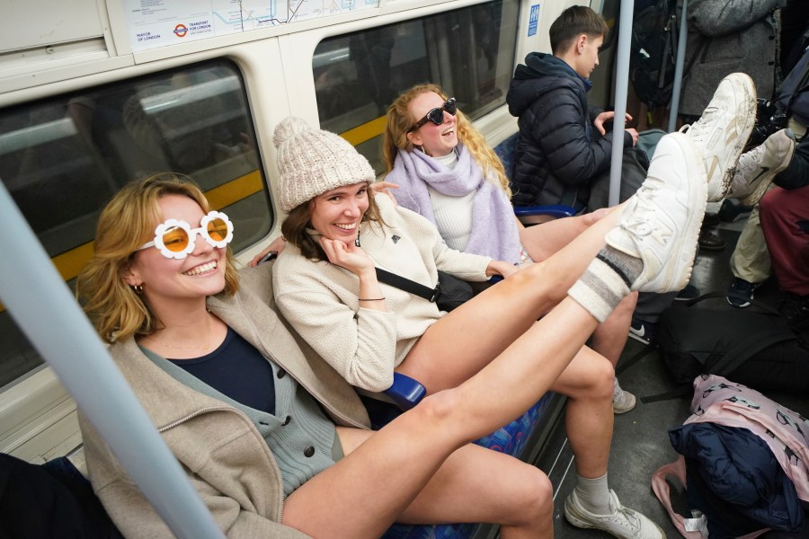 People on board a tube as they take part in the annual event "No Trousers Tube Ride" in London, Sunday, Jan. 12, 2025. (AP Photo/Alberto Pezzali)