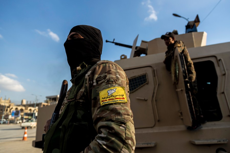 FILE - U.S.-backed Syrian Democratic Forces (SDF) fighters stand guard at Al Naeem Square, in Raqqa, Syria, Monday, Feb. 7, 2022. (AP Photo/Baderkhan Ahmad, File)