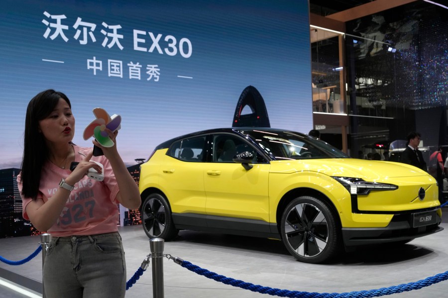 FILE - A live streamer works near the Volvo EX30 fully electric small SUV unveiled during Auto China 2024 in Beijing, Thursday, April 25, 2024. (AP Photo/Ng Han Guan, File)