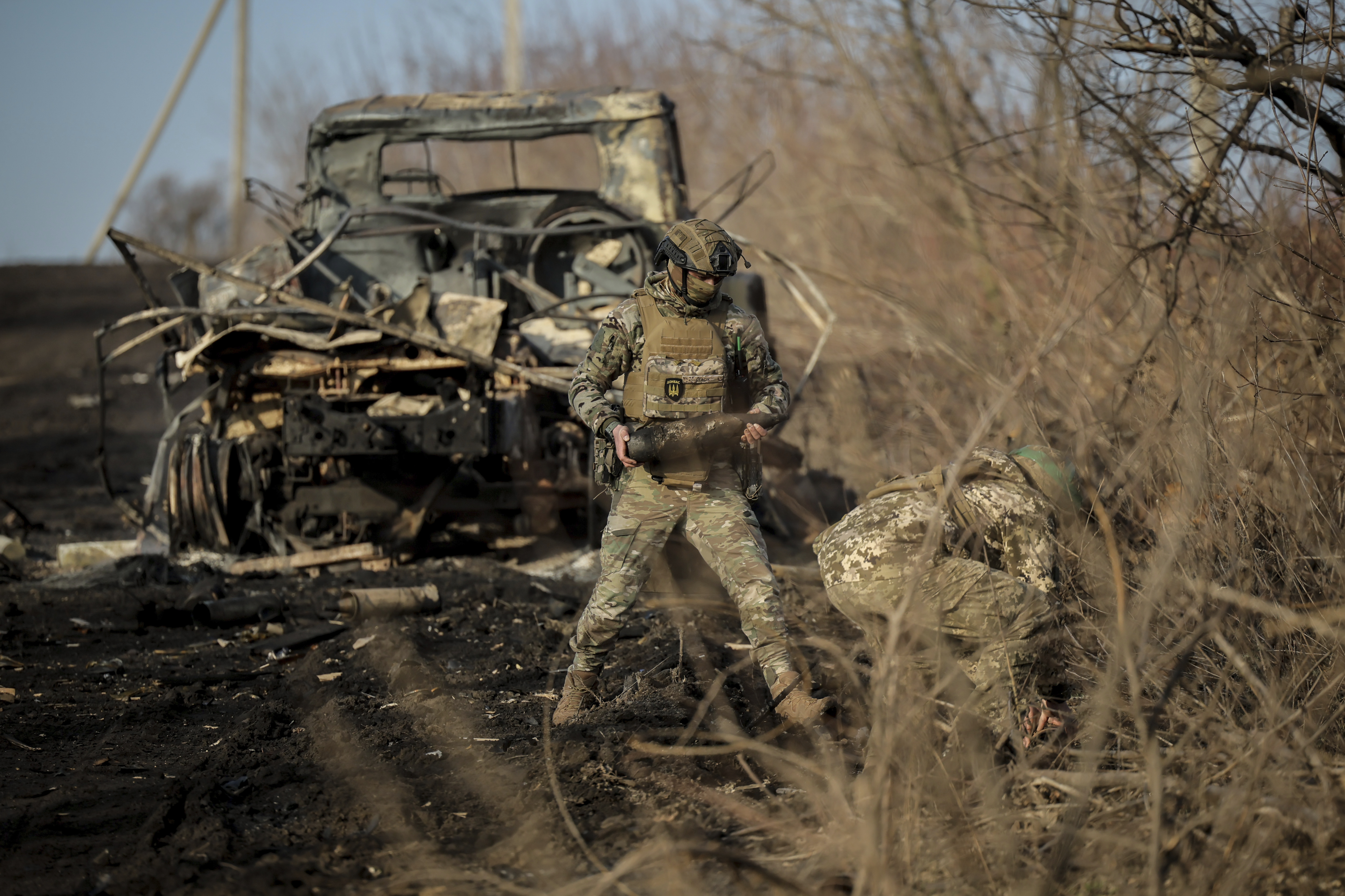 Ukrainian servicemen collect damaged ammunition on the road at the front line near Chasiv Yar town, in Donetsk region, Ukraine, Ukraine, Friday, Jan. 10, 2025. (Oleg Petrasiuk/Ukraine's 24th Mechanised Brigade via AP)