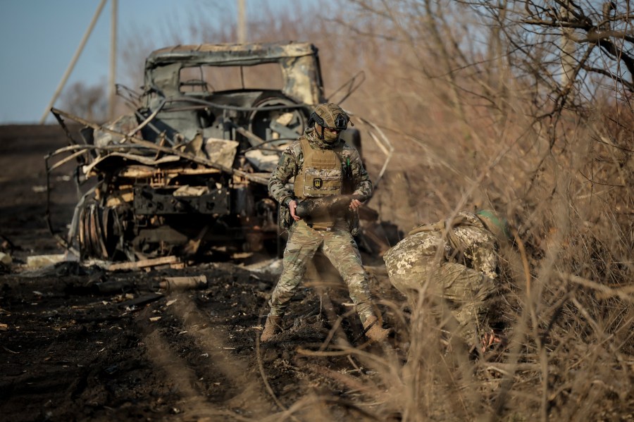 Ukrainian servicemen collect damaged ammunition on the road at the front line near Chasiv Yar town, in Donetsk region, Ukraine, Ukraine, Friday, Jan. 10, 2025. (Oleg Petrasiuk/Ukraine's 24th Mechanised Brigade via AP)