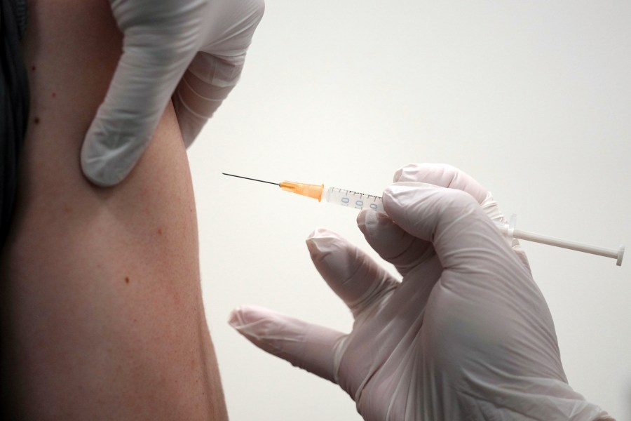 FILE - A local resident receives the Moderna COVID-19 vaccine shot at a center, June 30, 2021, in the Sumida ward of Tokyo. (AP Photo/Eugene Hoshiko, File)