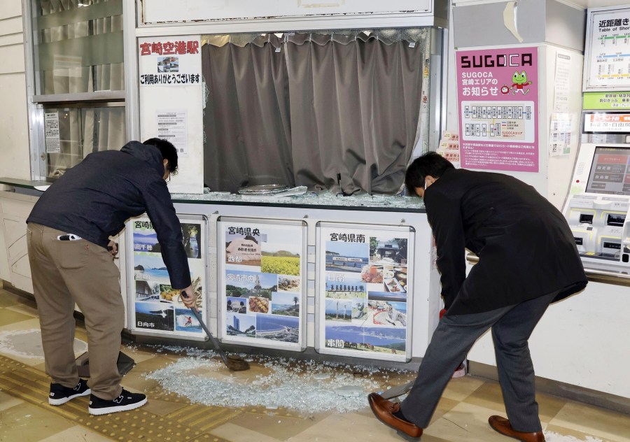 Staff clean up shattered and scattered glass caused by the earthquake at JR Miyazaki Airport Station, in Miyazaki, in southwestern Japan, Monday Jan. 13, 2025. (Kyodo News via AP)