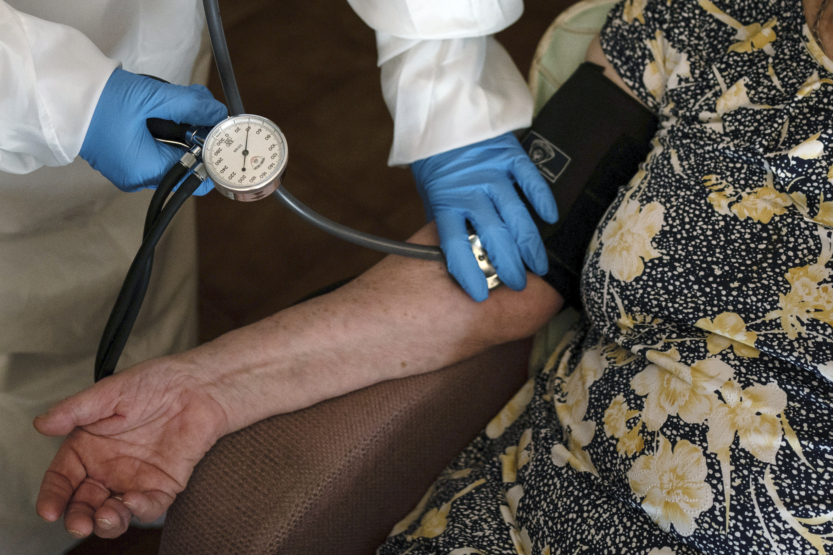 FILE - A doctor checks the blood pressure of A 94-year-old woman in Sant Sadurní d'Anoia, Catalonia region, Spain, Friday, July 31, 2020. (AP Photo/Felipe Dana, File)