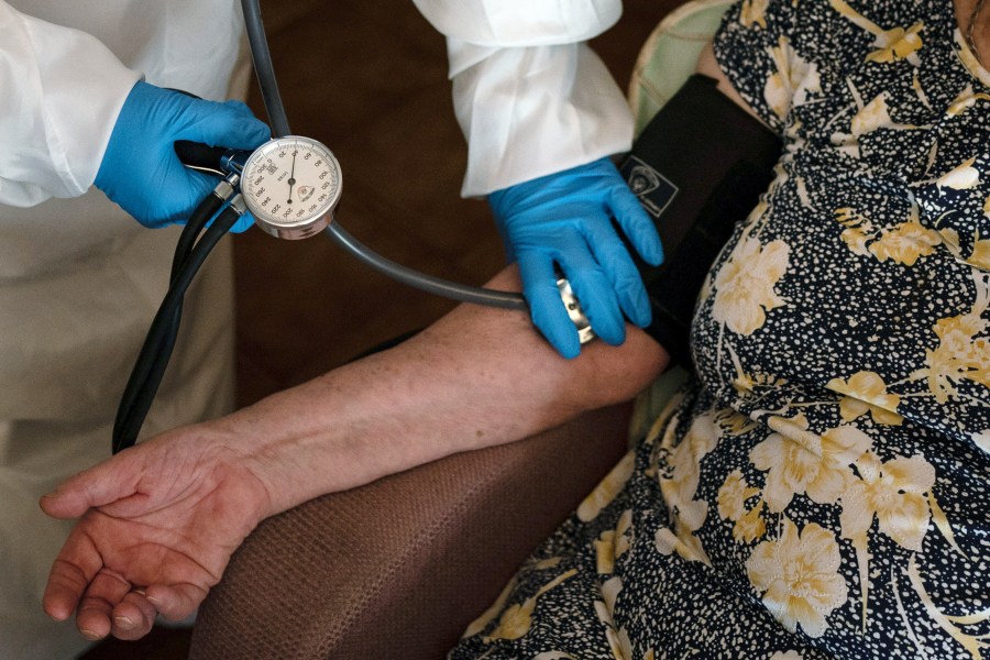 FILE - A doctor checks the blood pressure of A 94-year-old woman in Sant Sadurní d'Anoia, Catalonia region, Spain, Friday, July 31, 2020. (AP Photo/Felipe Dana, File)