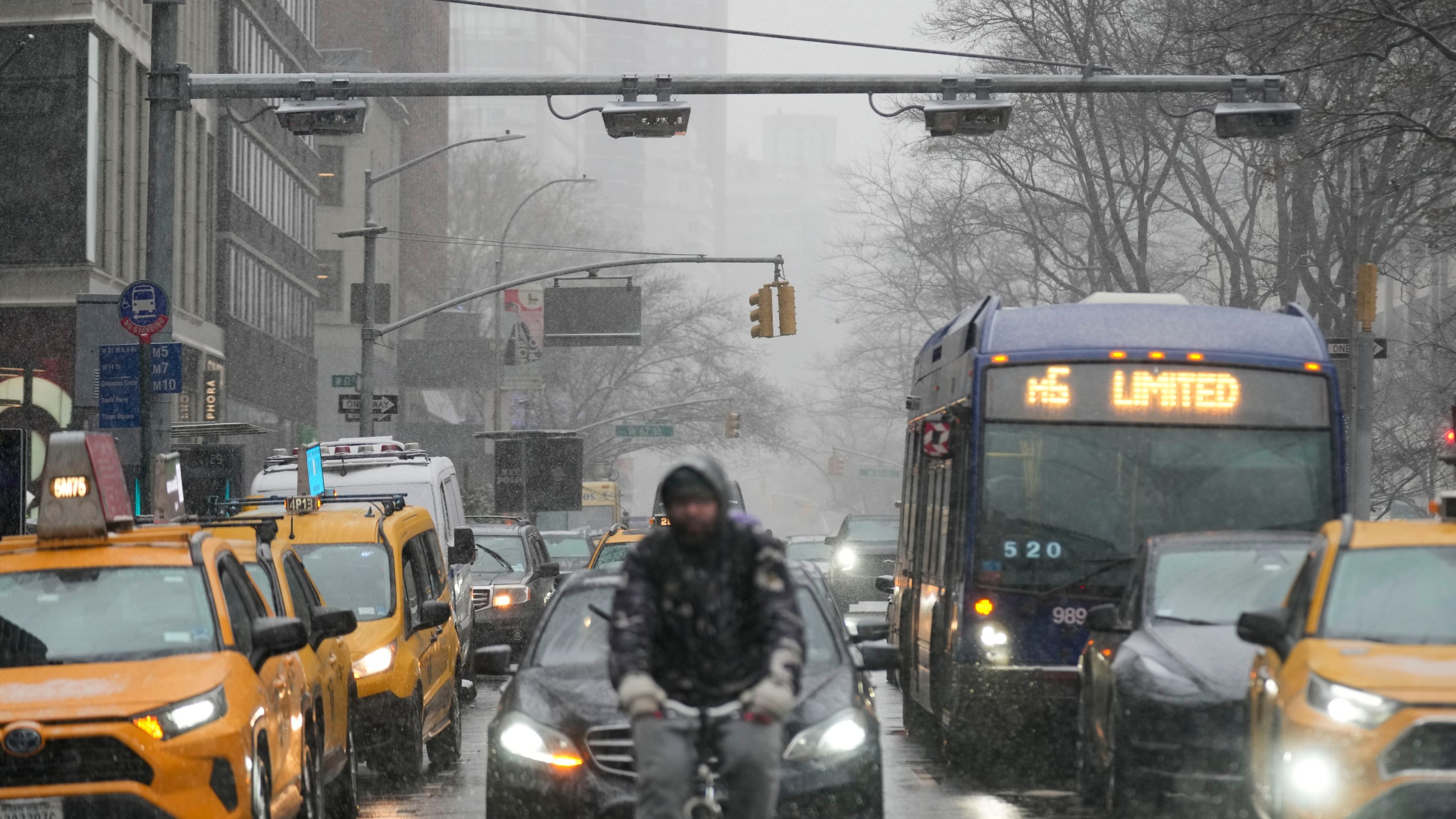 Devices used for congestion tolling hang above traffic on a Manhattan street in New York, Monday, Jan. 6, 2025. (AP Photo/Seth Wenig)