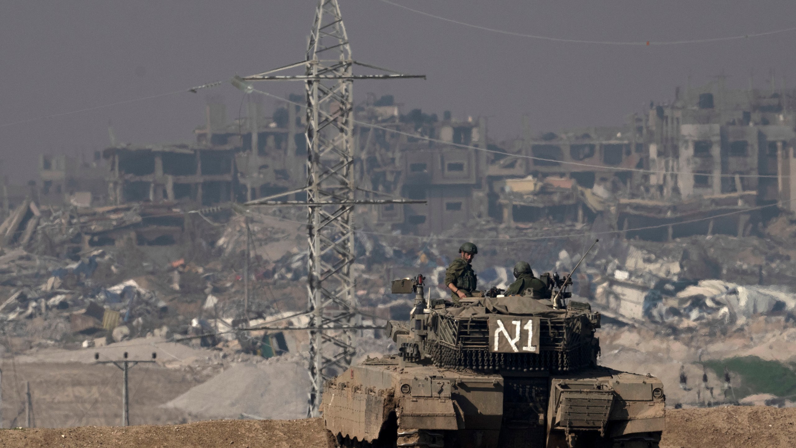 FILE - Israeli soldiers overlook the Gaza Strip from a tank, as seen from southern Israel, on Friday, Jan. 19, 2024. (AP Photo/Maya Alleruzzo, File)