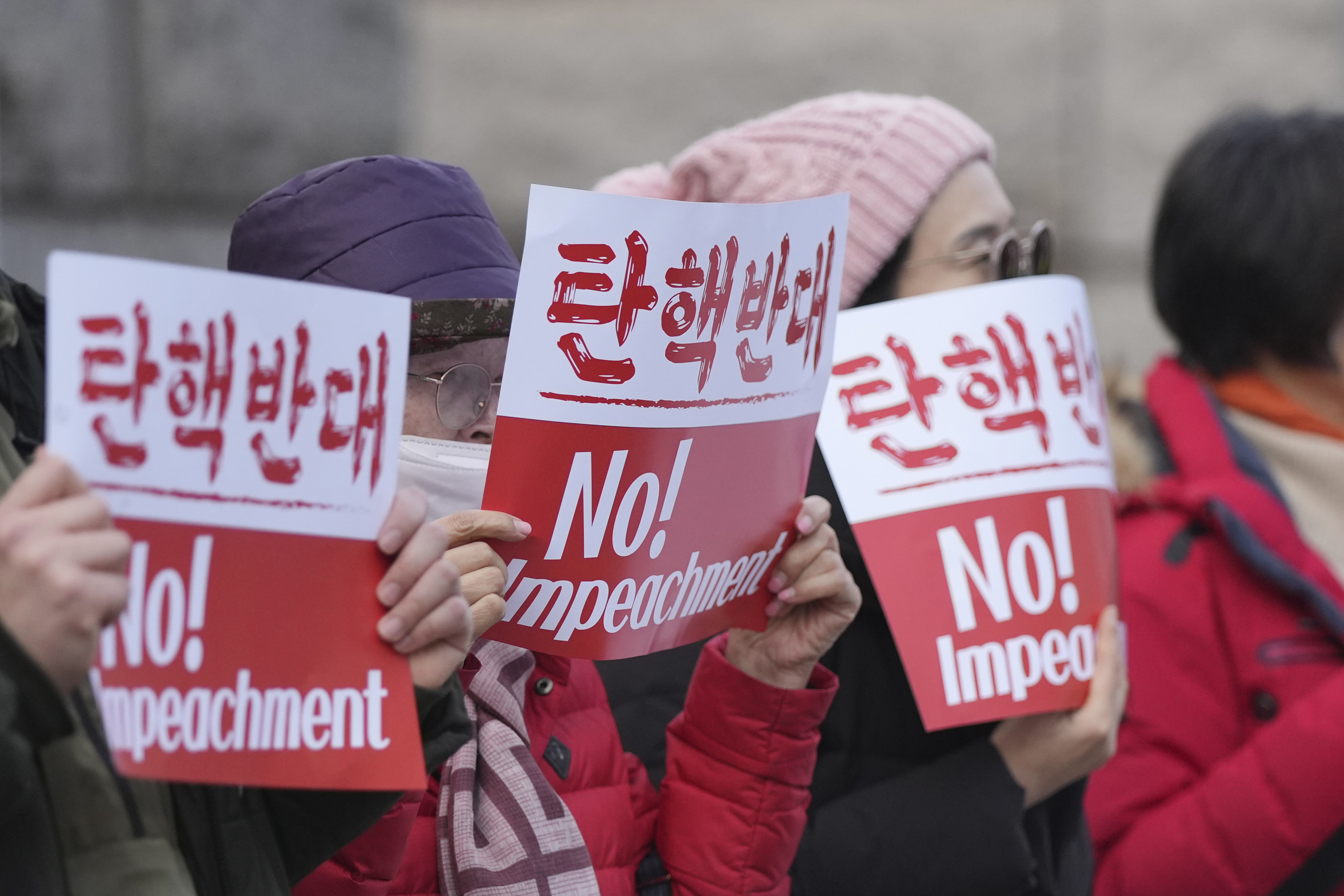 Supporters of impeached South Korean President Yoon Suk Yeol hold signs during a rally to oppose his impeachment outside the Constitutional Court in Seoul, South Korea, Tuesday, Jan. 14, 2025. (AP Photo/Lee Jin-man)