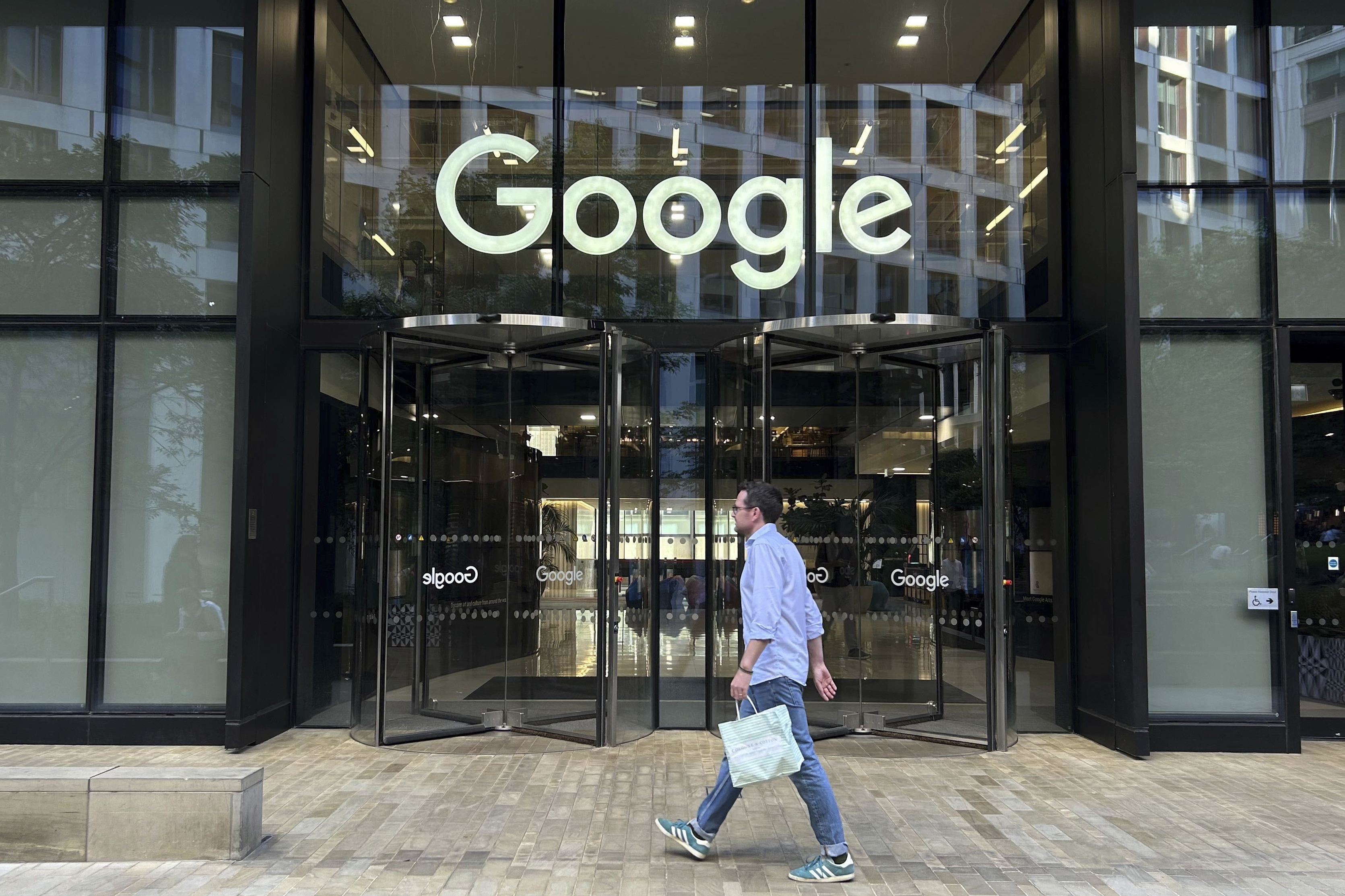 FILE - A man walks past Google's offices in London's Kings Cross area, on Aug. 10, 2024. (AP Photo/Brian Melley, File)