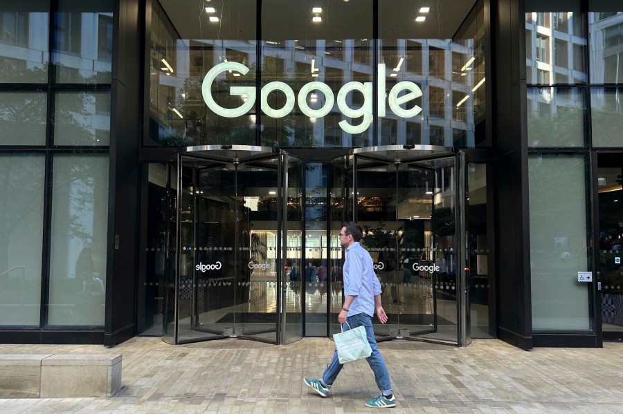 FILE - A man walks past Google's offices in London's Kings Cross area, on Aug. 10, 2024. (AP Photo/Brian Melley, File)