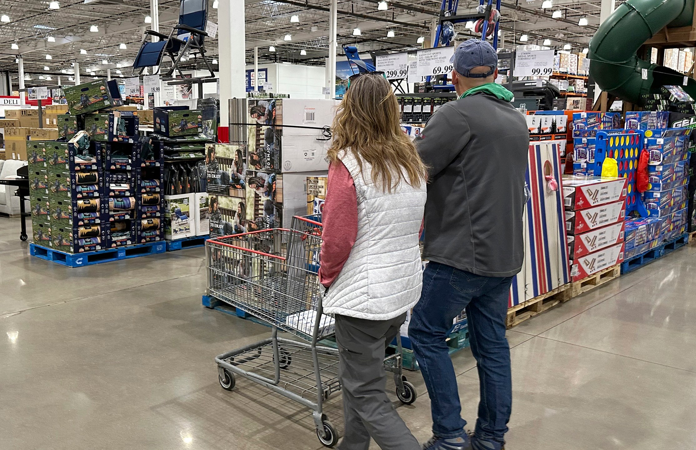 FILE - Shoppers pass displays of goods in a Costco warehouse Sunday, Feb. 25, 2024, in Sheridan, Colo. (AP Photo/David Zalubowski, File)