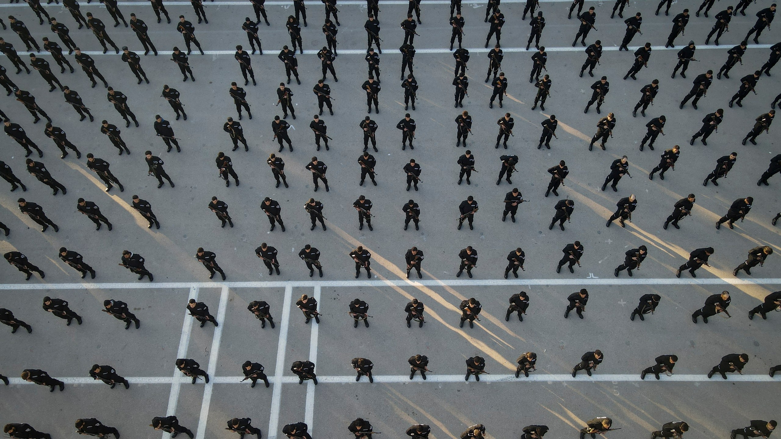 Recruits for the new government's police force stand in formation during a training and graduation session at the Police College in Damascus, Syria, Tuesday Jan. 14, 2025.(AP Photo/Omar Albam)