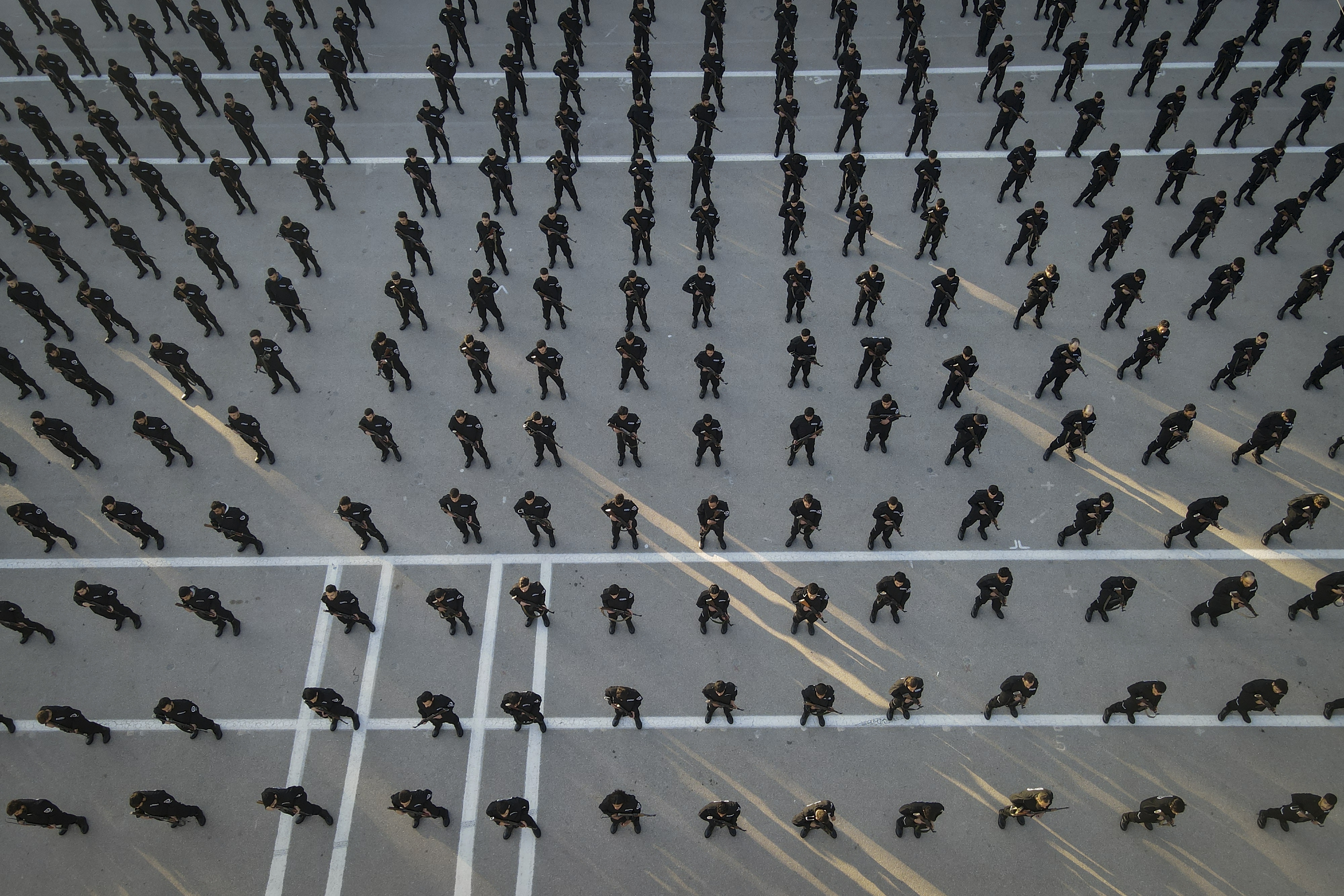 Recruits for the new government's police force stand in formation during a training and graduation session at the Police College in Damascus, Syria, Tuesday Jan. 14, 2025.(AP Photo/Omar Albam)