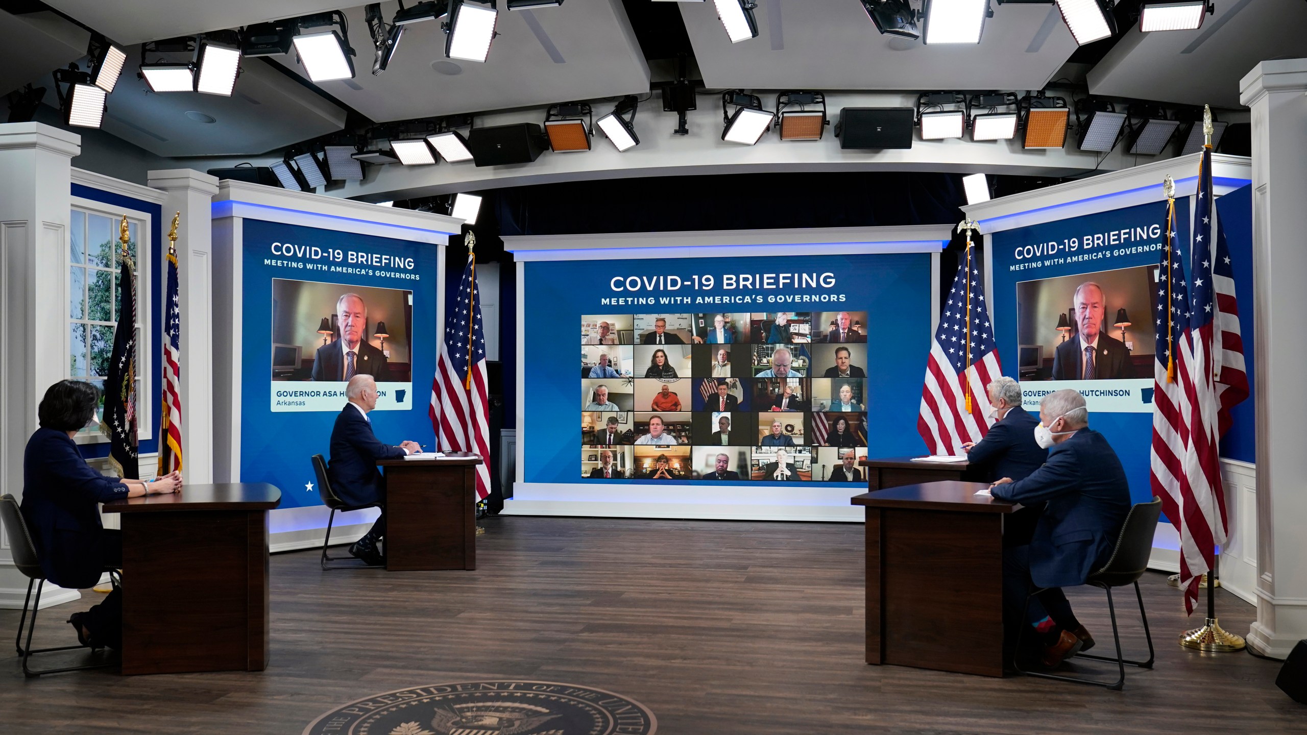 FILE - President Joe Biden, second left, participates in the White House COVID-19 Response Team's regular call with the National Governors Association in the South Court Auditorium in the Eisenhower Executive Office Building on the White House Campus, Monday, Dec. 27, 2021, in Washington. Seated with the President from left Dr. Rochelle Walensky, Director of the Centers for Disease Control and Prevention, Biden, Jeff Zients, COVID-19 Response Coordinator and Dr. Anthony Fauci, White House Chief Medical Advisor and Director of the NIAID. (AP Photo/Carolyn Kaster, File)