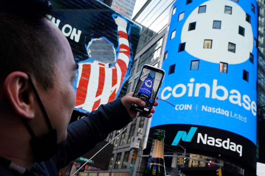 FILE - The Coinbase logo covers the Nasdaq MarketSite in New York's Times Square, April 14, 2021. (AP Photo/Richard Drew, File)