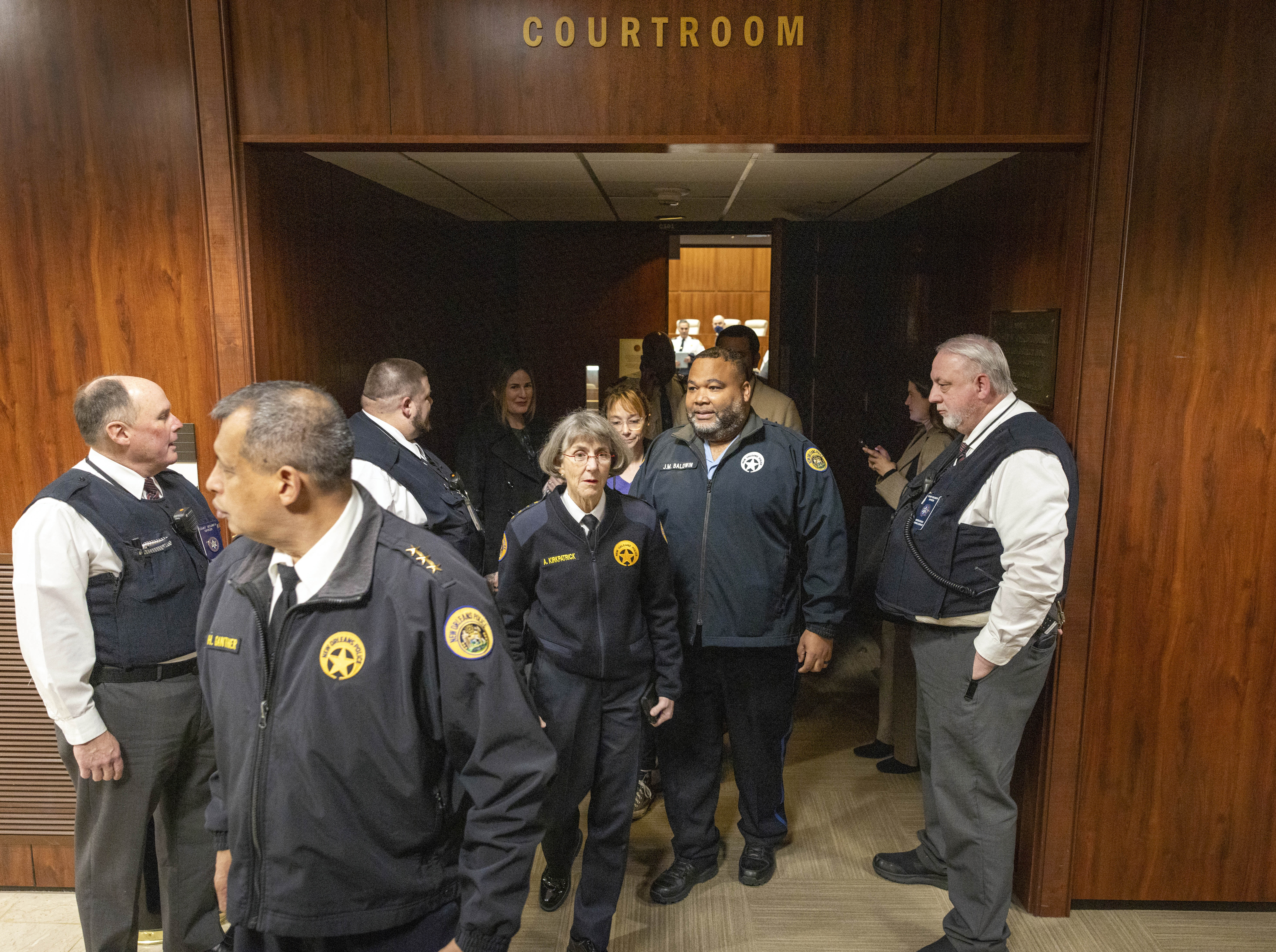 New Orleans Police Superintendent Anne Kirkpatrick, center, along with her NOPD district chiefs, walks out of Federal Court, Tuesday, Jan. 14, 2025, in New Orleans, after a judge ruled the New Orleans Police Department can begin the process of ending longstanding federal oversight. (Chris Granger/The Times-Picayune/The New Orleans Advocate via AP)