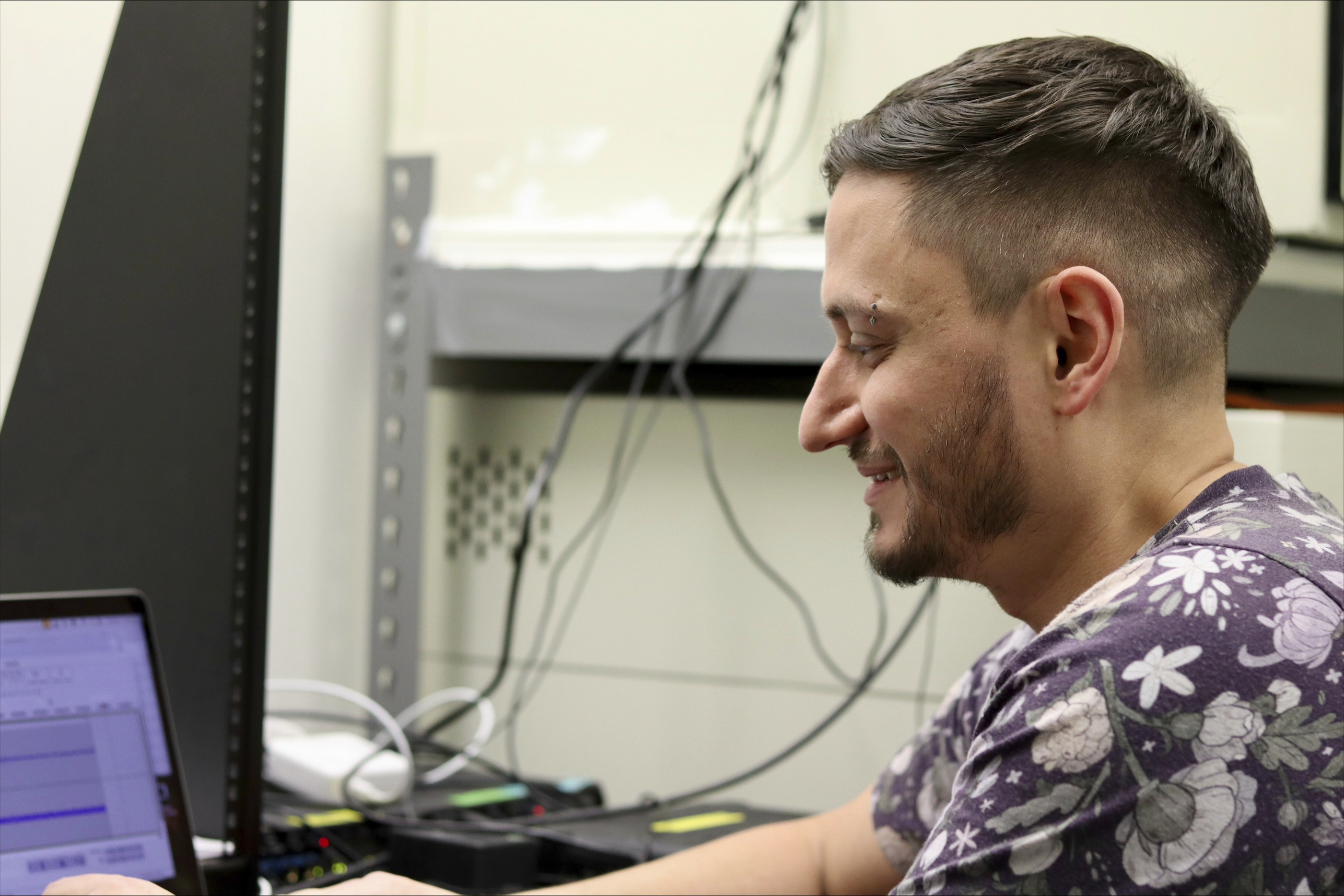 McGill University postdoctoral fellow Logan James, an affiliated researcher with the nonprofit Earth Species Project, examines zebra finch recordings on Thursday, Dec. 12, 2024 in Montreal, Canada. (AP Photo/James Pollard)