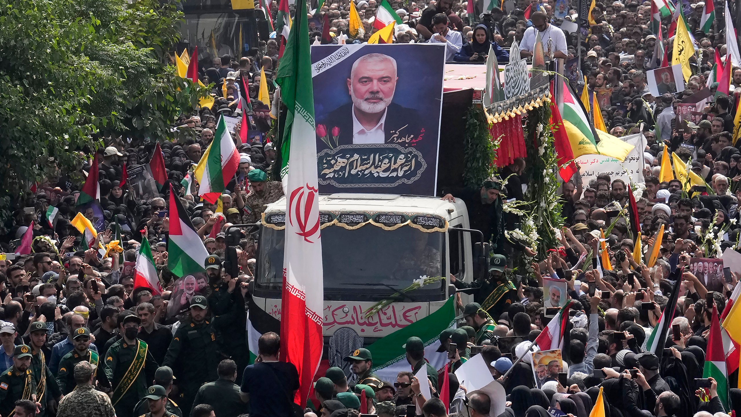 FILE - Iranians follow a truck carrying the coffins of Hamas leader Ismail Haniyeh and his bodyguard who were killed in an Israeli assassination during their funeral ceremony at Enqelab-e-Eslami (Islamic Revolution) Sq. in Tehran, Iran, Aug. 1, 2024. (AP Photo/Vahid Salemi, File)