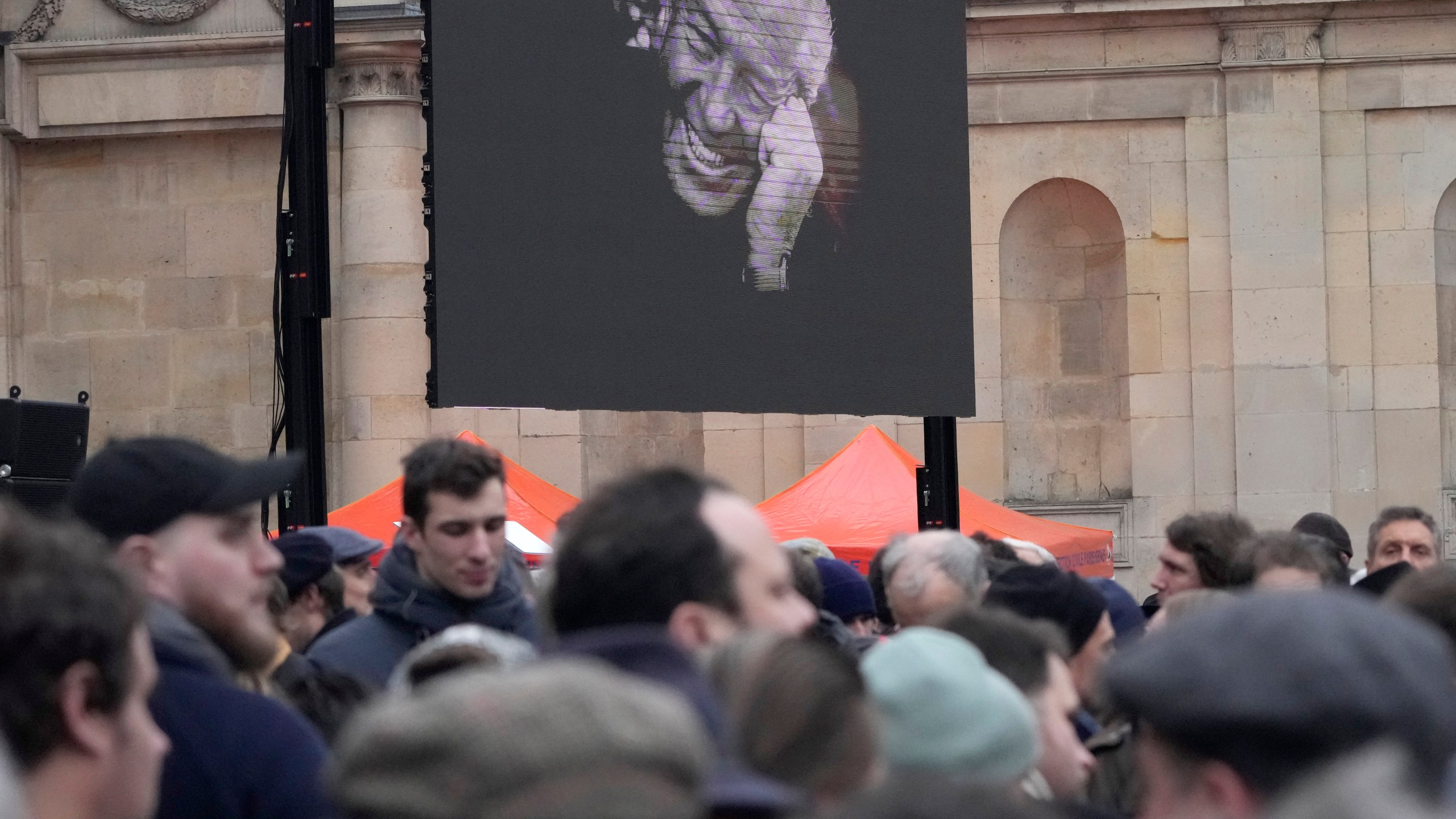 People wait outside Notre Dame du Val-de-Grace church before a public memorial for late far-right leader Jean-Marie Le Pen, Thursday, Jan. 16, 2025 in Paris. Jean-Marie Le Pen, the founder of France's main far-right party, died on Jan.7, 2025 aged 96. (AP Photo/Michel Euler)