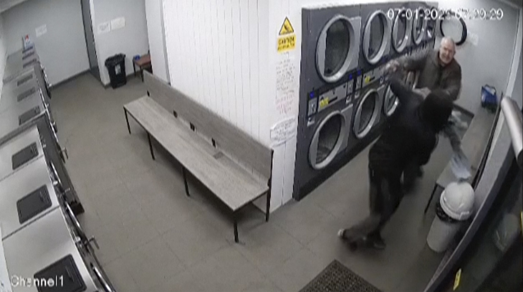 In this grab taken from CCTV from a Launderette in Maltby, a man fights off a mugger with a pair of trousers, in Maltby, England. (CCTV from a Launderette in Maltby via AP)