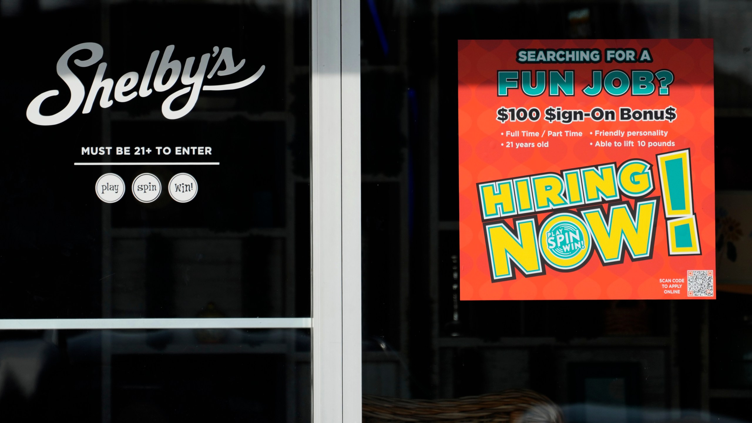 A hiring sign is displayed at a cafe in Streamwood, Ill., Tuesday, Dec. 3, 2024. (AP Photo/Nam Y. Huh)