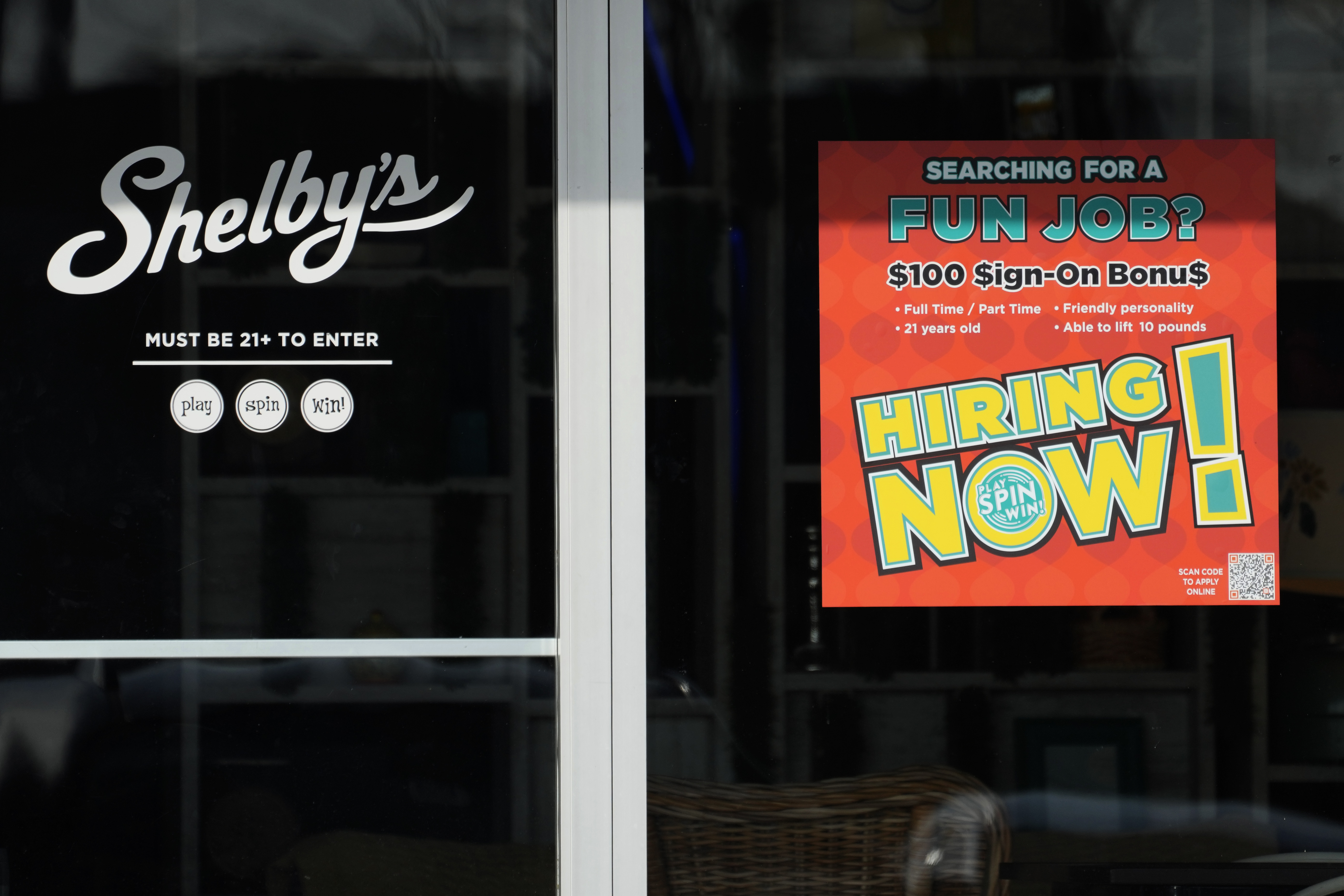 A hiring sign is displayed at a cafe in Streamwood, Ill., Tuesday, Dec. 3, 2024. (AP Photo/Nam Y. Huh)